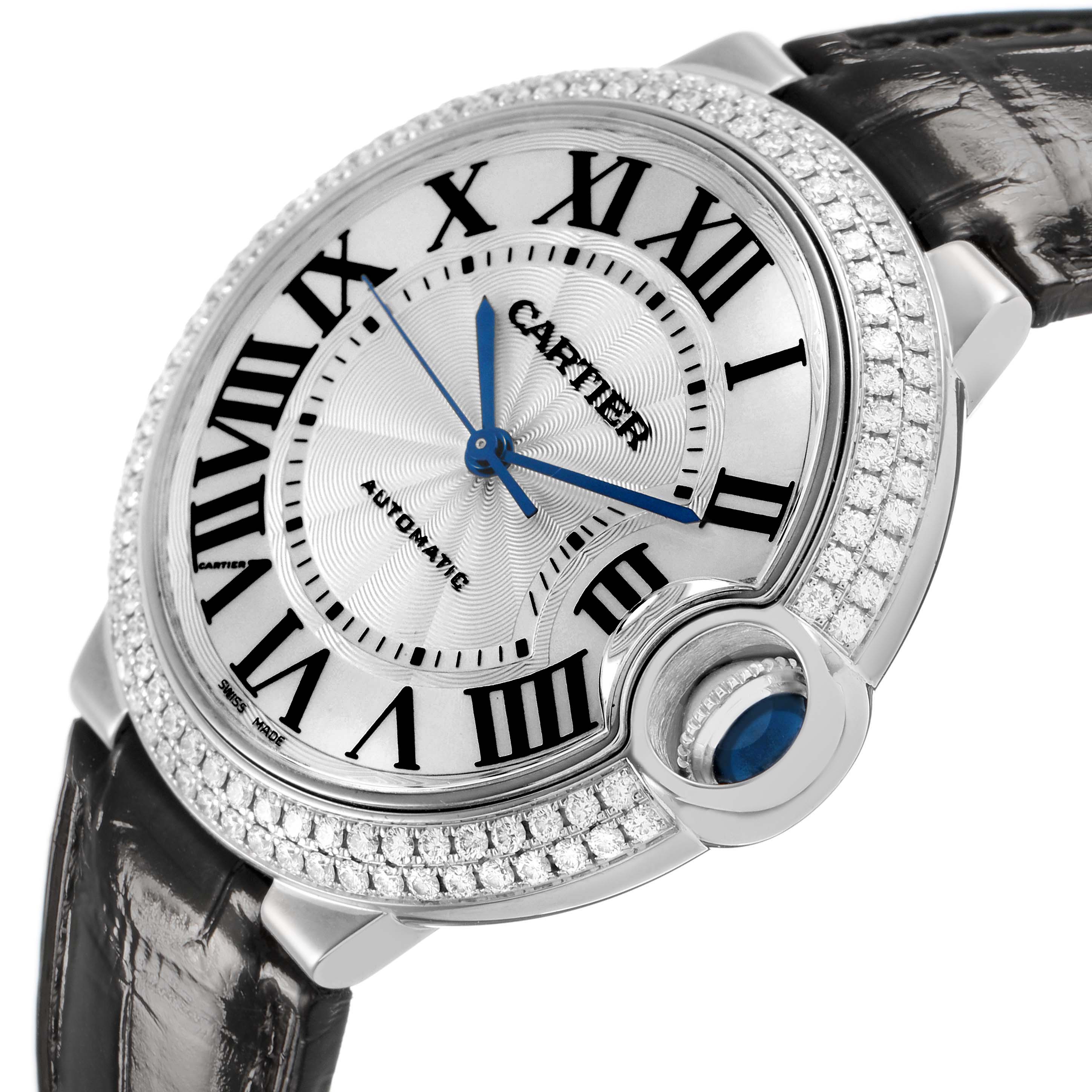 The Cartier Ballon Bleu WE900651 Women's White Gold White Dial watch is shown at an angle highlighting the dial, roman numerals, diamond bezel, and crown with a blue cabochon.