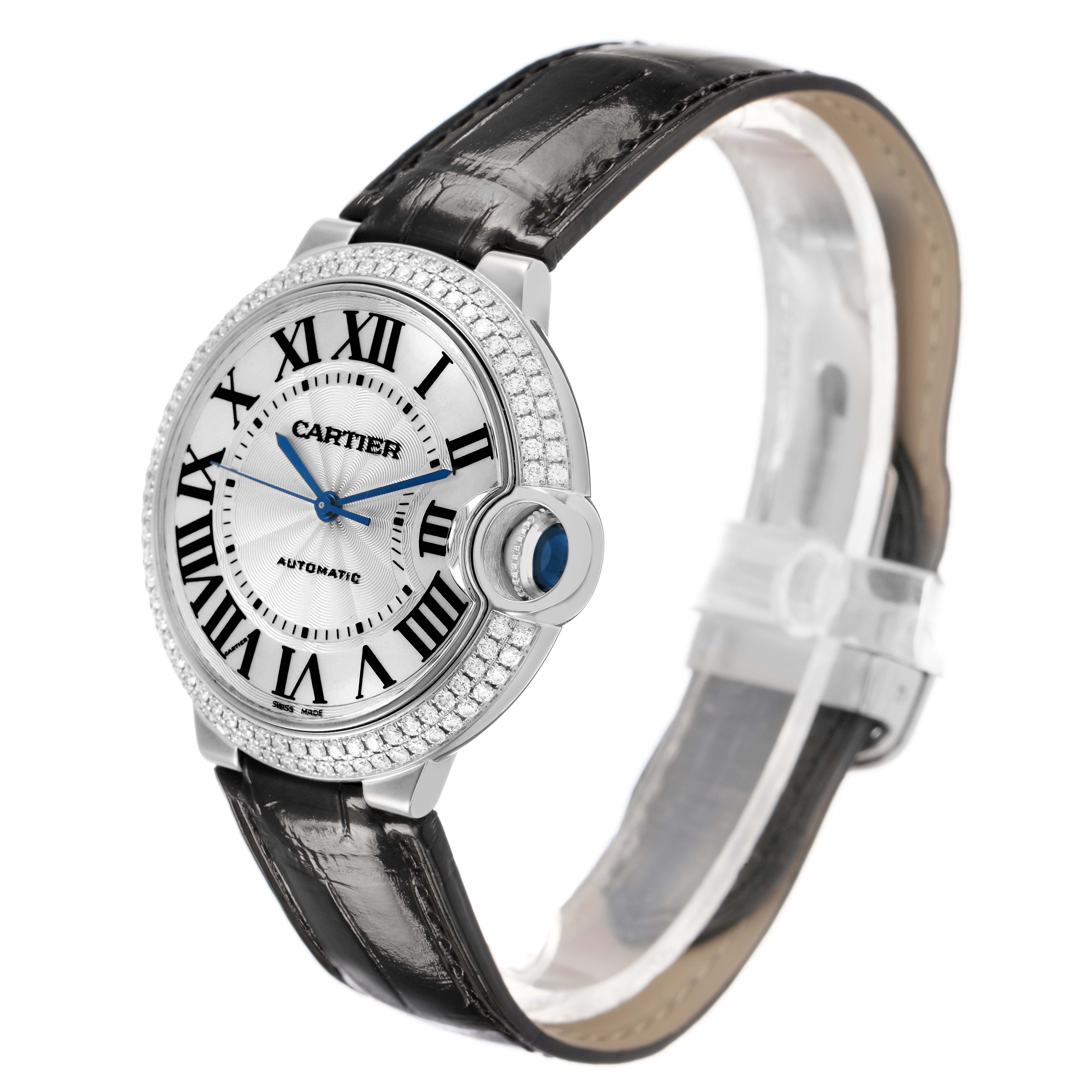 The Cartier Ballon Bleu WE900651 Women's White Gold White Dial watch is shown at a three-quarter angle, highlighting the face, case, crown, and leather strap.