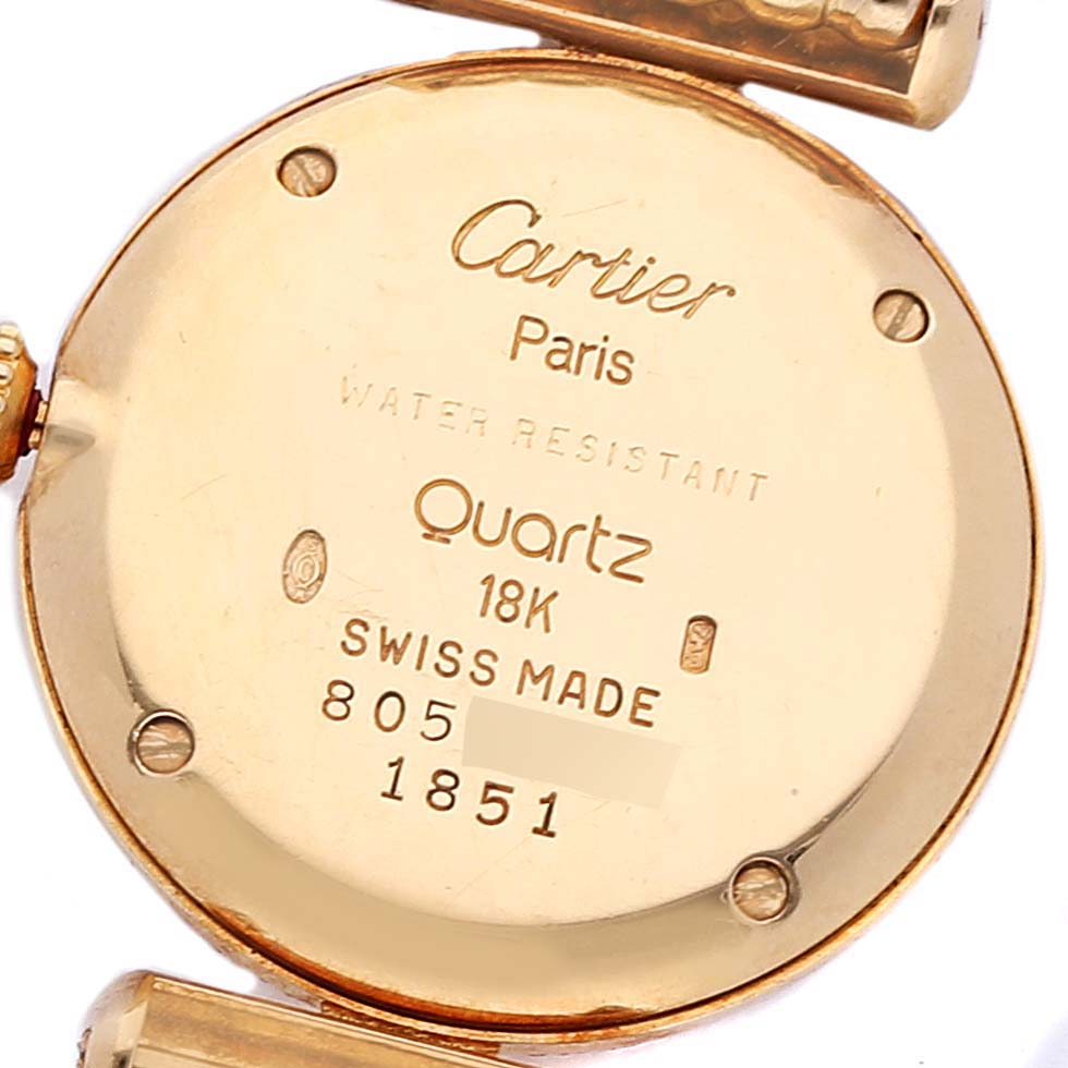 The image shows the back case of a Cartier Colisee WB1018A8 Women's Yellow Gold Silver Dial WB1018A8 Women's Yellow Gold Silver Dial watch, revealing its inscriptions and gold material.