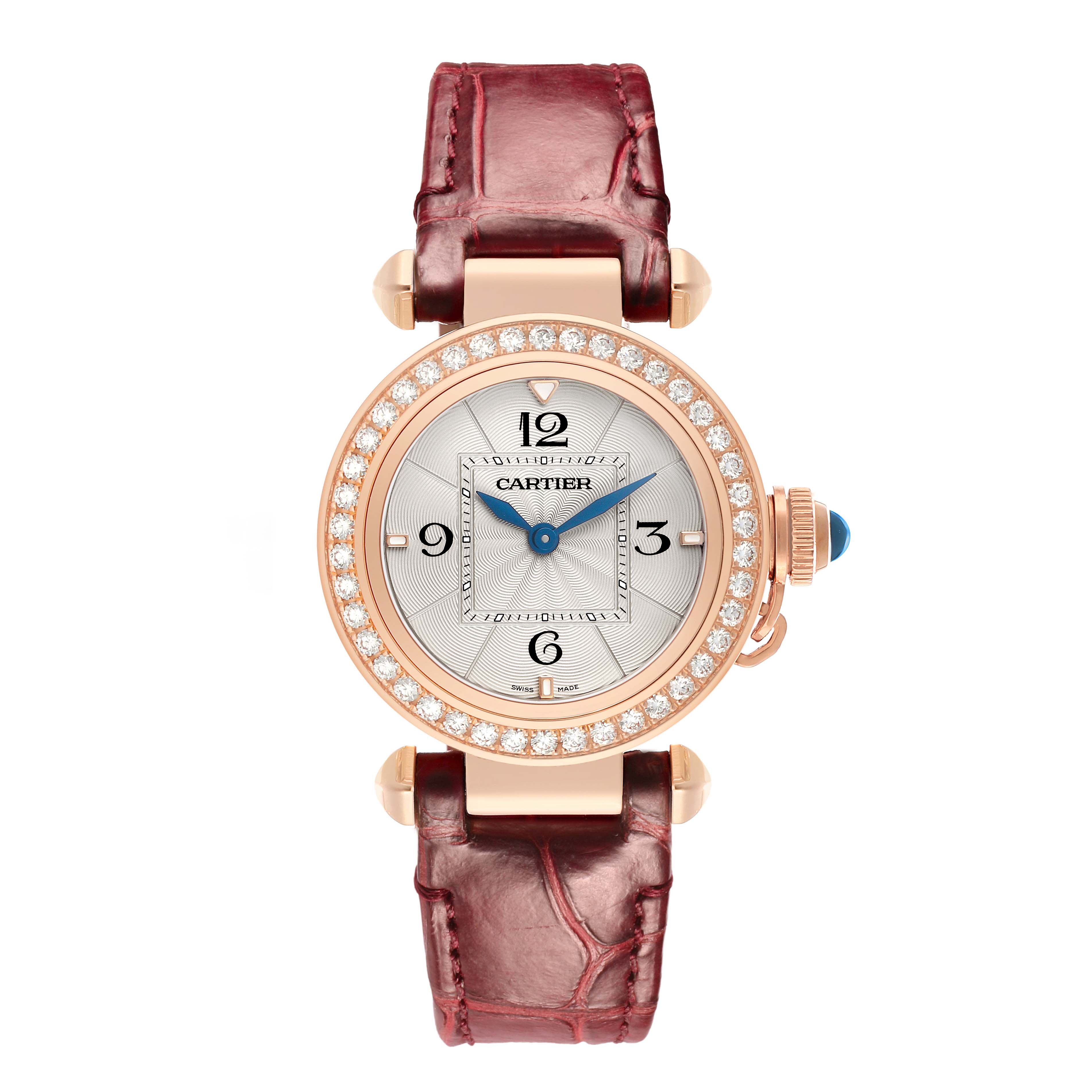 The Cartier Pasha WJPA0017 Women's Rose Gold White Dial watch is shown from the front, featuring a diamond bezel, blue hands, and a burgundy strap.