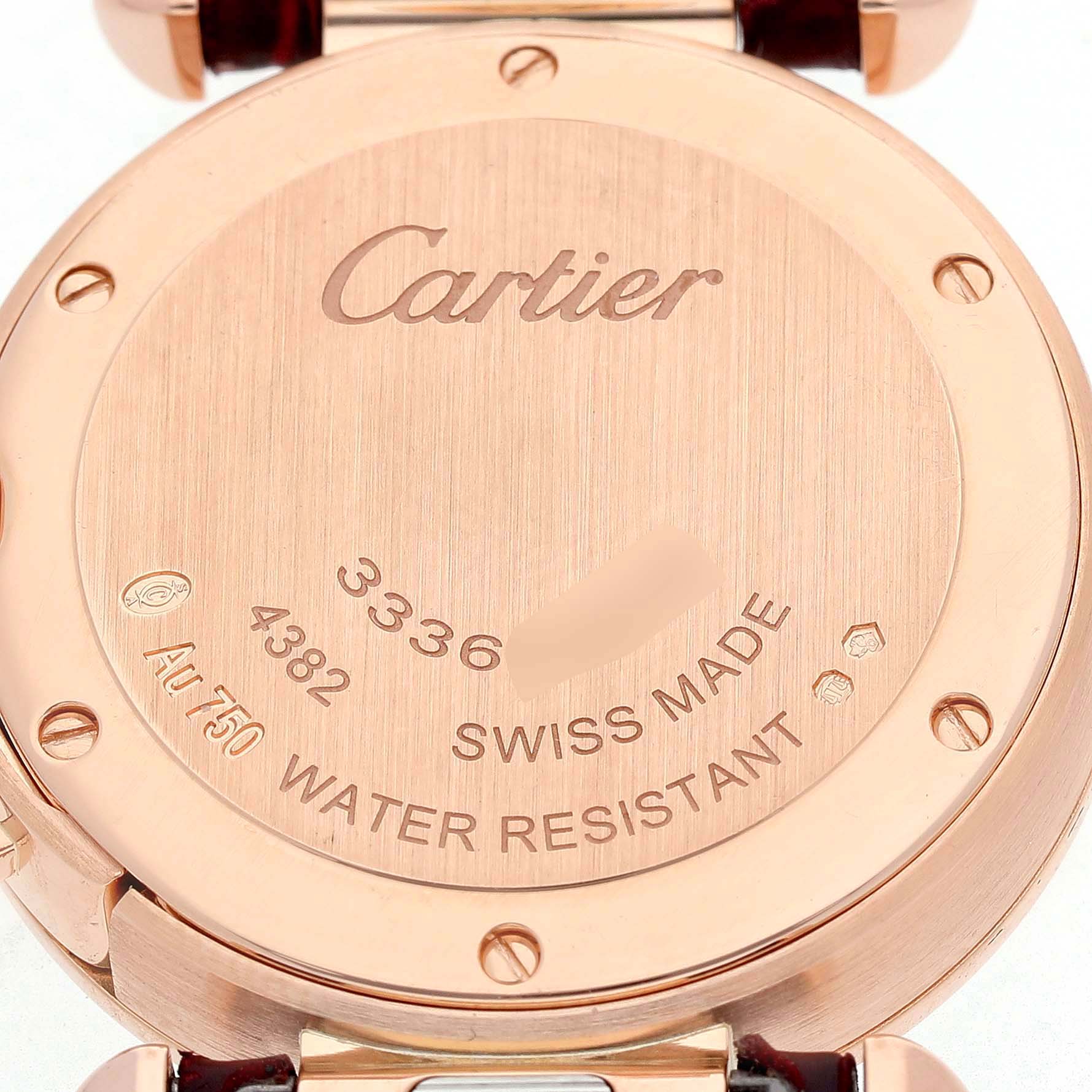 The image shows the back case of a Cartier Pasha WJPA0017 Women's Rose Gold White Dial watch, highlighting engravings and water resistance details.