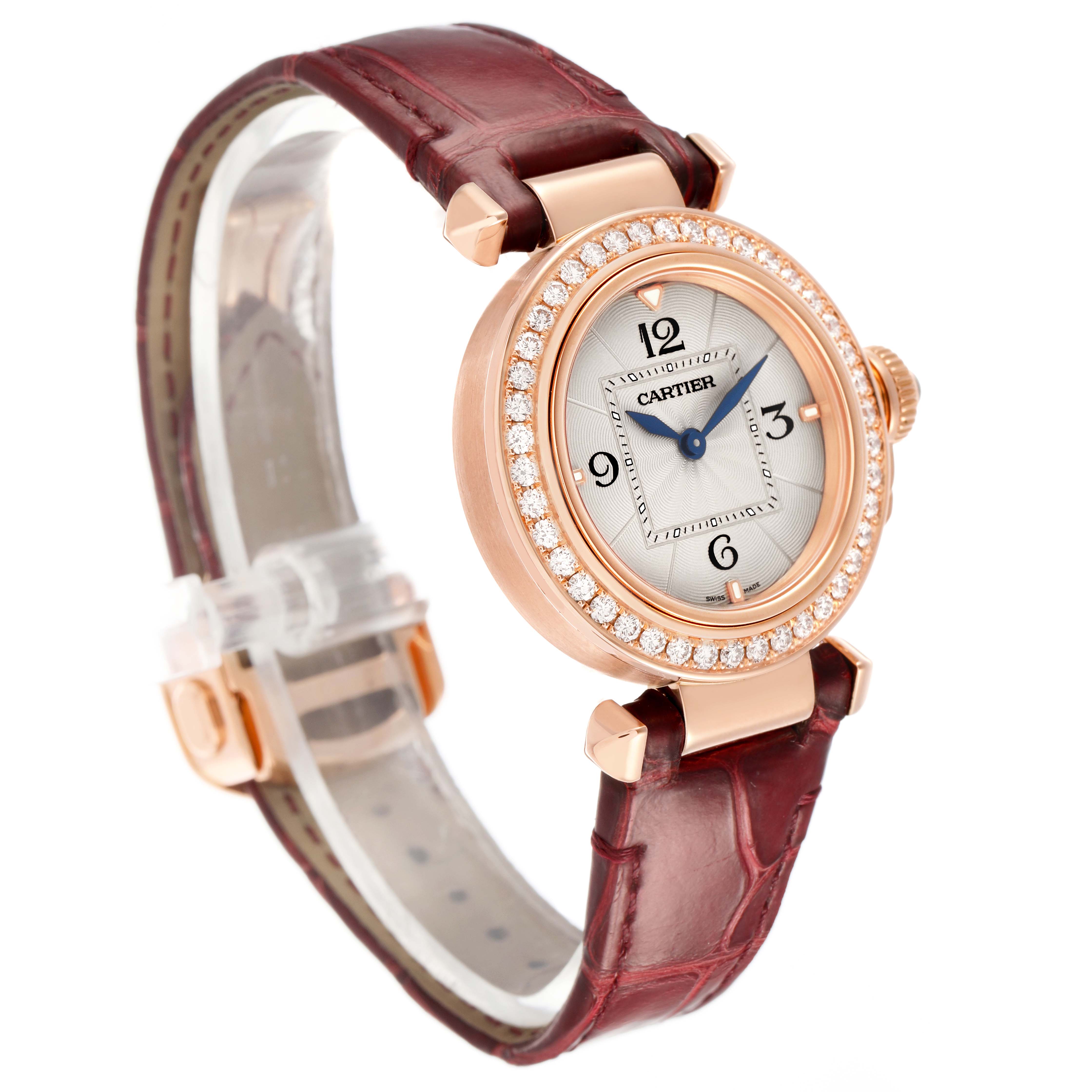 The Cartier Pasha WJPA0017 Women's Rose Gold White Dial watch is shown at a side angle, highlighting its diamond bezel, rose gold case, and maroon leather strap.