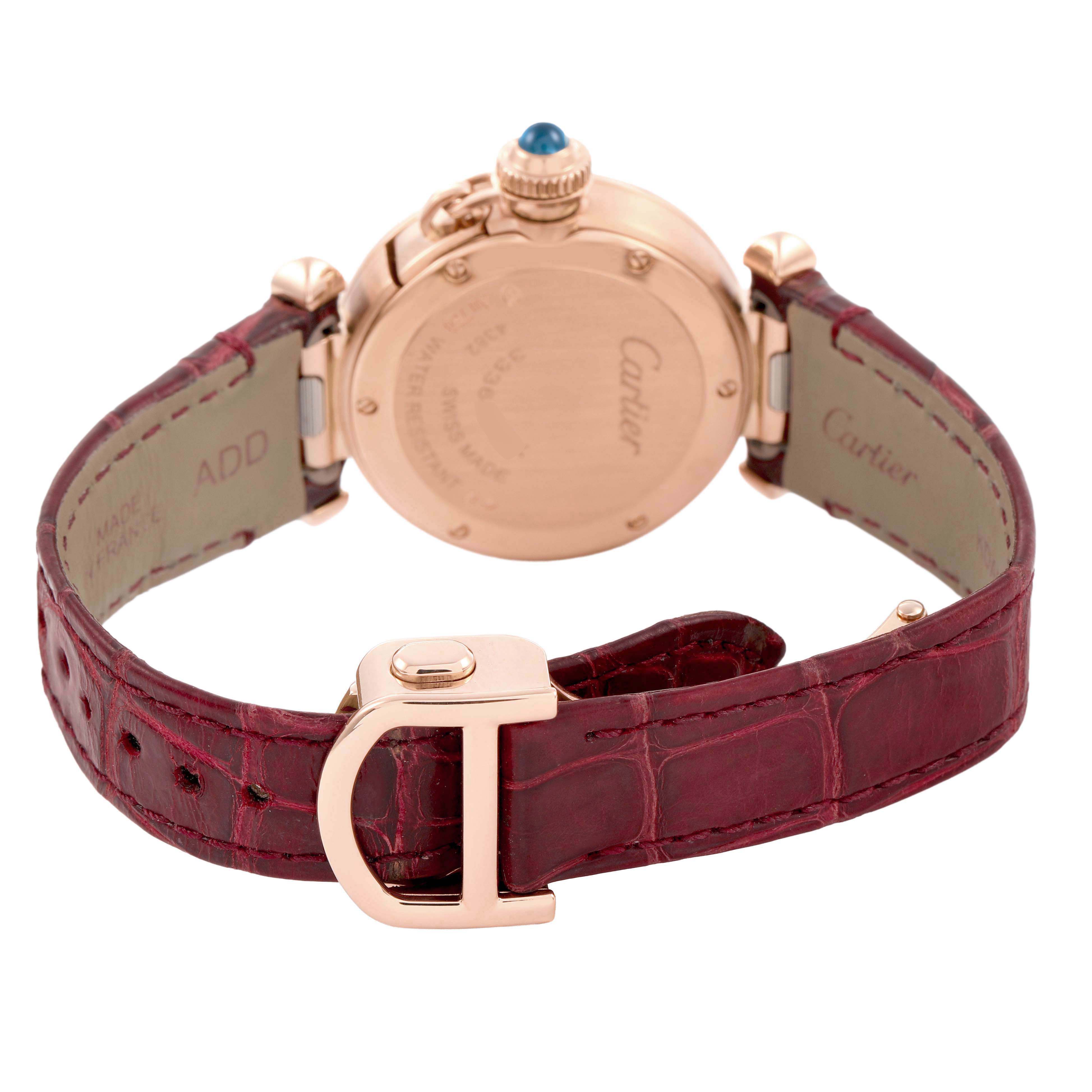 The image shows the back of a Cartier Pasha WJPA0017 Women's Rose Gold White Dial watch, highlighting the case back, crown, and red leather strap with a clasp.
