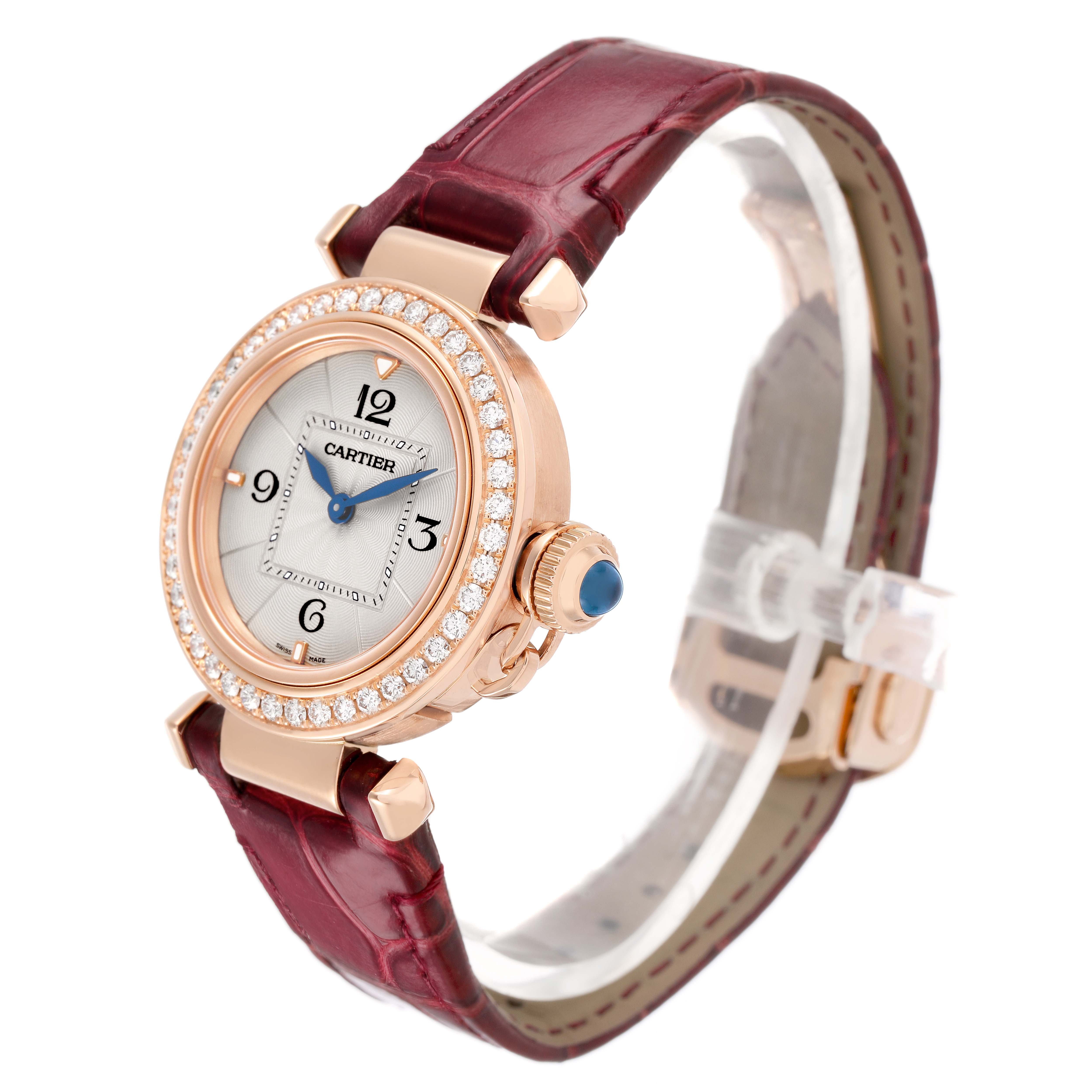 The Cartier Pasha WJPA0017 Women's Rose Gold White Dial watch is shown at a 3/4 angle, highlighting its dial, bezel, crown, and strap.
