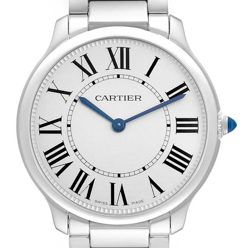 The Cartier Ronde WSRN0034 Men's Stainless Steel Silver Dial watch is shown from a front angle, highlighting its face, Roman numerals, blued hands, and metal bracelet.