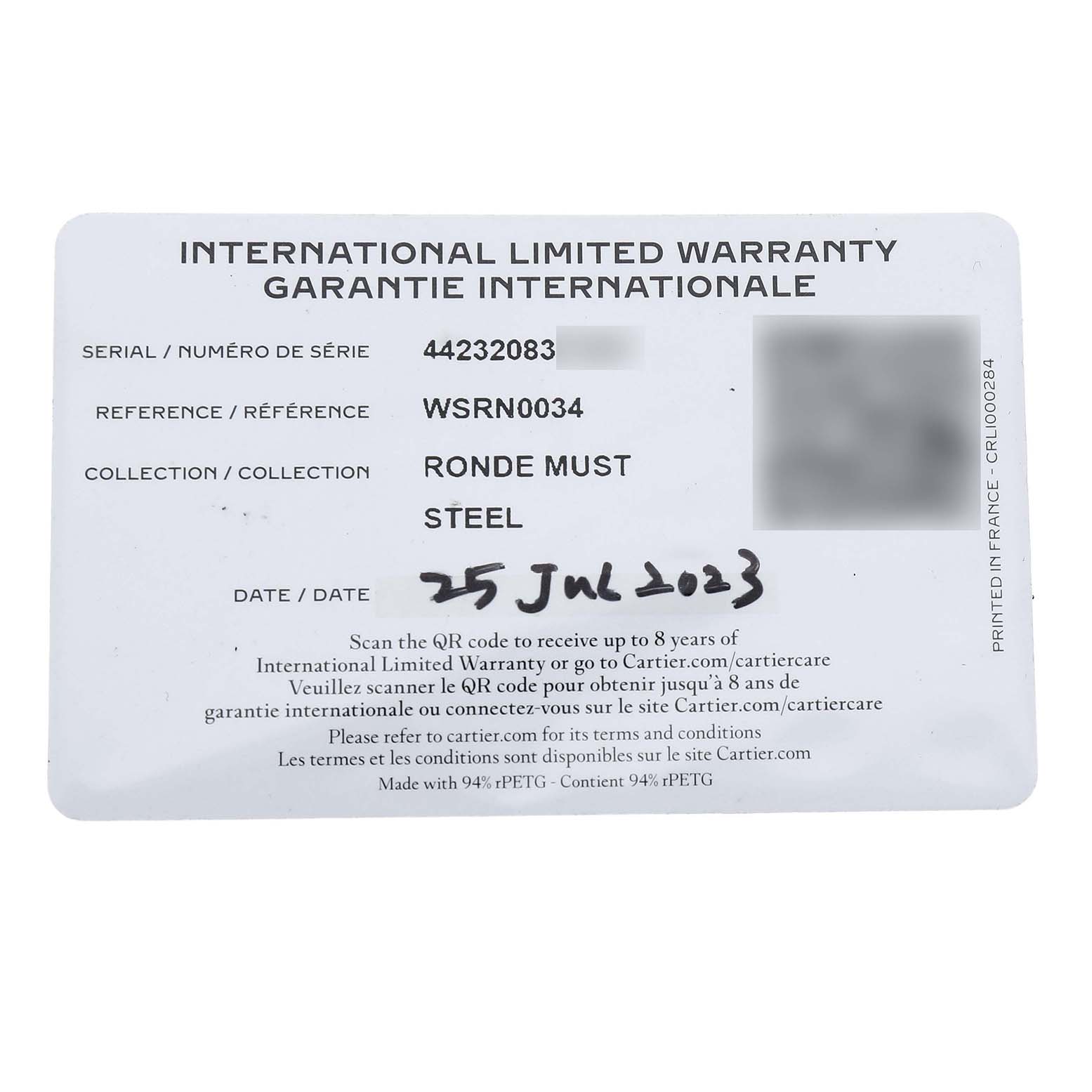 The image shows an international limited warranty card for the Cartier Ronde WSRN0034 Men's Stainless Steel Silver Dial Must model.
