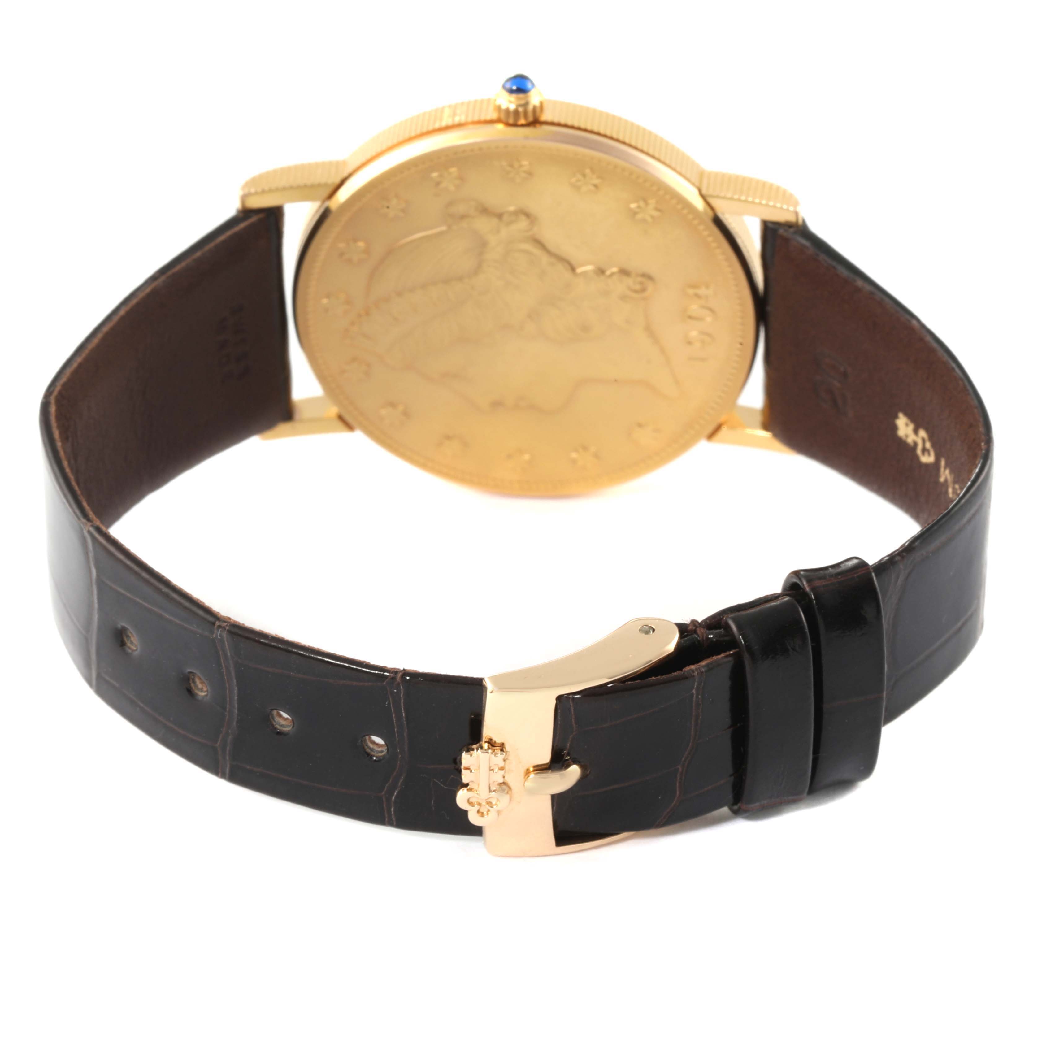 The image shows the back and strap of a Corum Coin Watch Men's Yellow Gold Black Dial Men's Yellow Gold Black Dial model, highlighting its buckle and leather band.