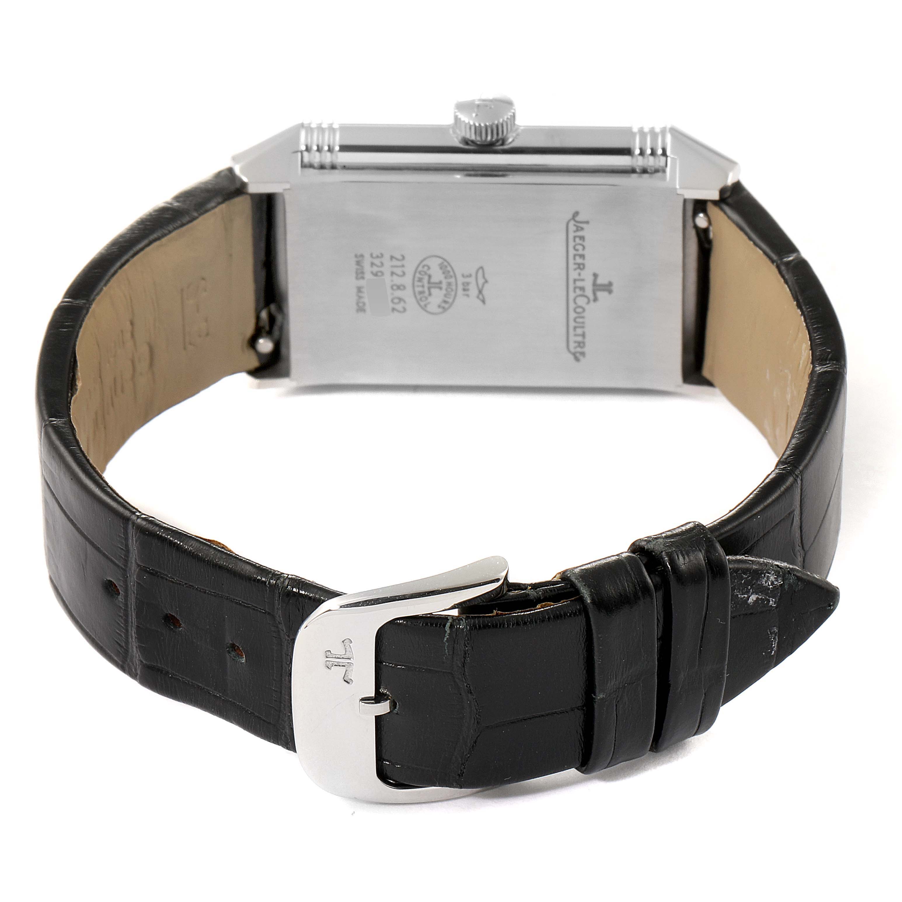 The image shows the back of a Jaeger-LeCoultre Reverso watch with a black leather strap and buckle.