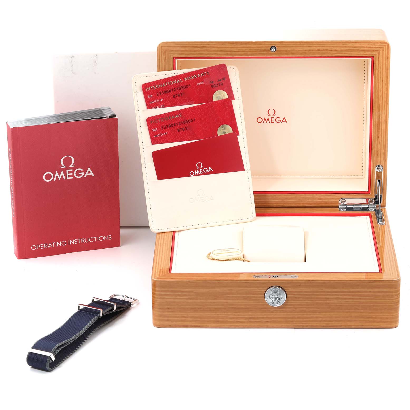 The image shows the packaging and accessories of an Omega Seamaster 233.90.41.21.03.001 Men's Titanium Blue Dial 233.90.41.21.03.001 Men's Titanium Blue Dial model, including the box, warranty cards, instruction manual, and strap.