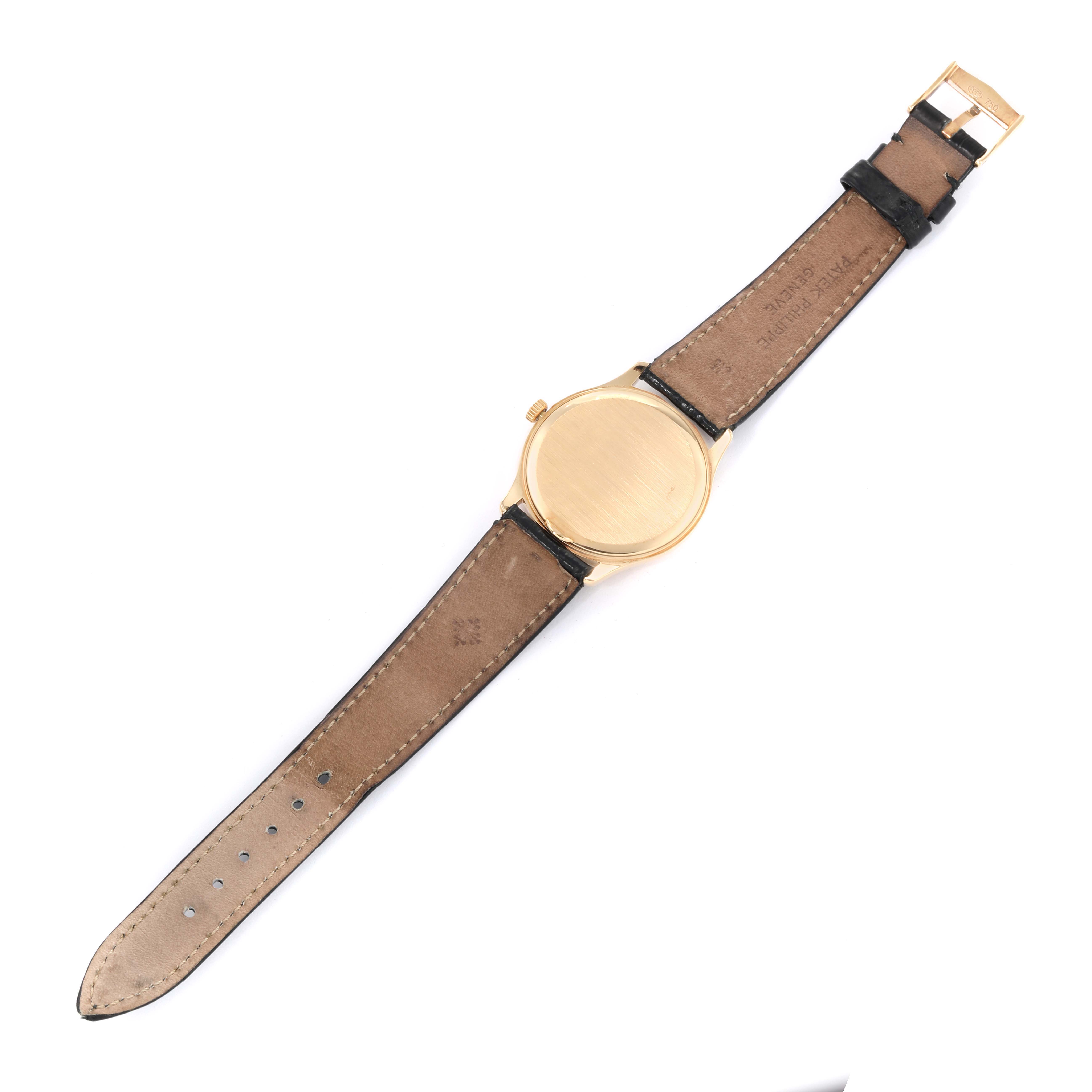 The image shows the back view of a Patek Philippe Calatrava 3923J Men's Yellow Gold Silver Dial 3923J Men's Yellow Gold Silver Dial watch, displaying the case back, leather strap, and buckle.