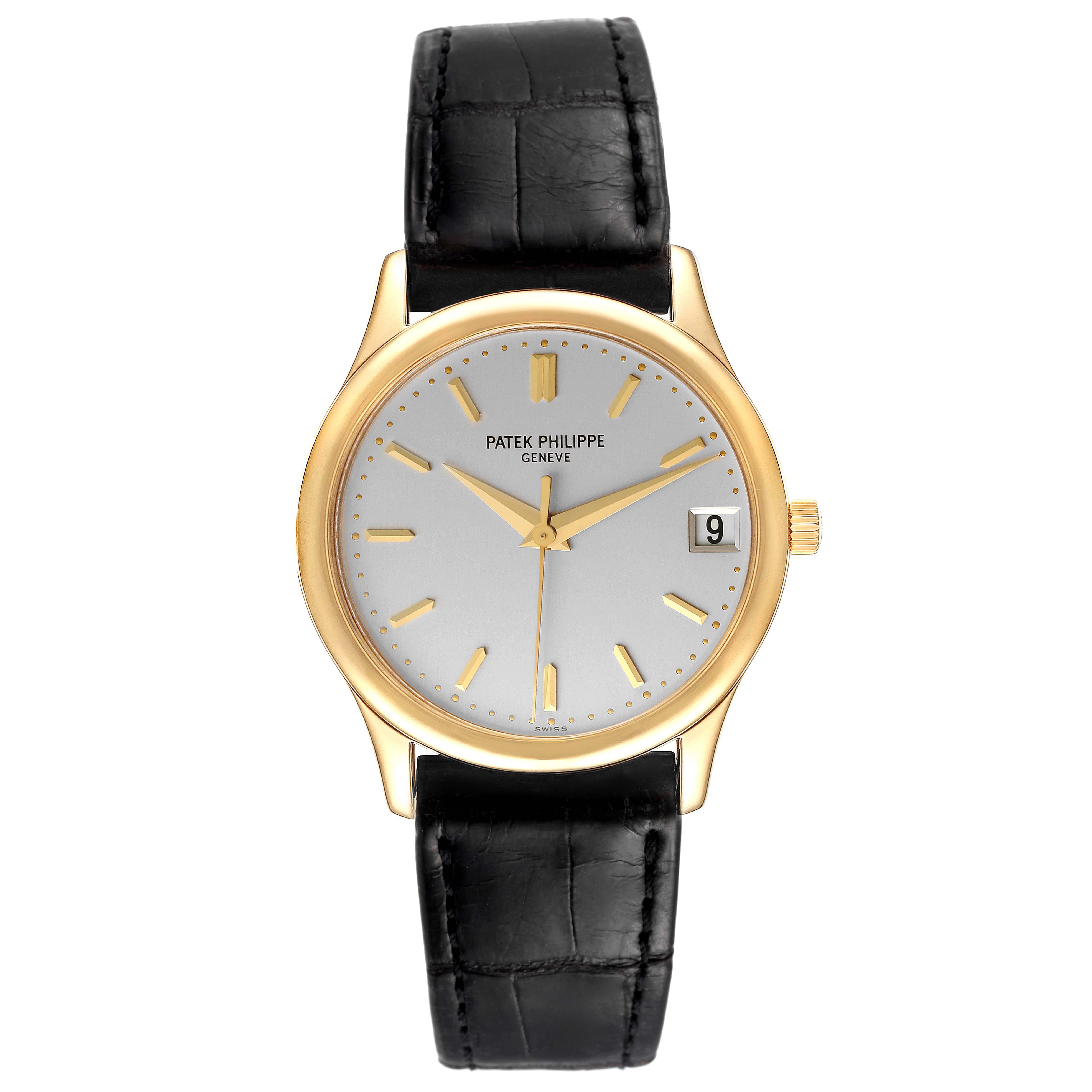 The image shows a front view of a Patek Philippe Calatrava 3998J Men's Yellow Gold Silver Dial 3998J Men's Yellow Gold Silver Dial watch with a gold case, white dial, black leather strap, and date display.