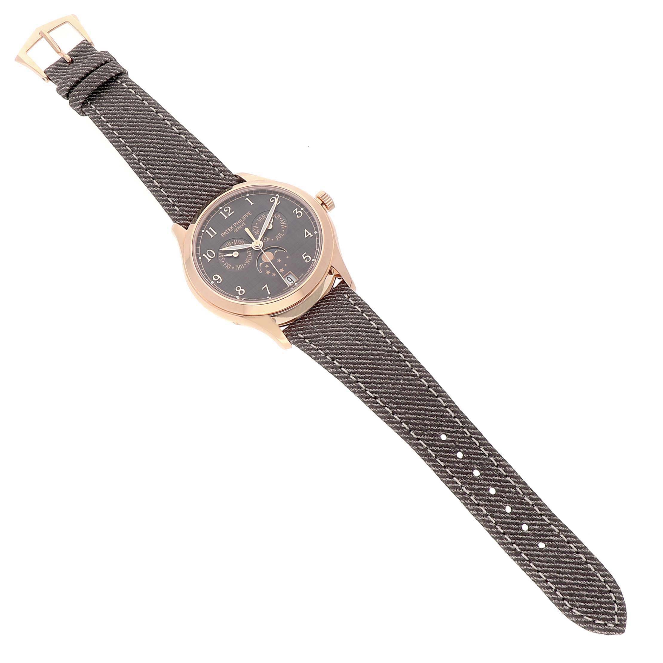 The Patek Philippe Complications 4946R-001 Men's Rose Gold Brown Dial watch is shown at an angle, displaying the face, case, crown, and textile strap.