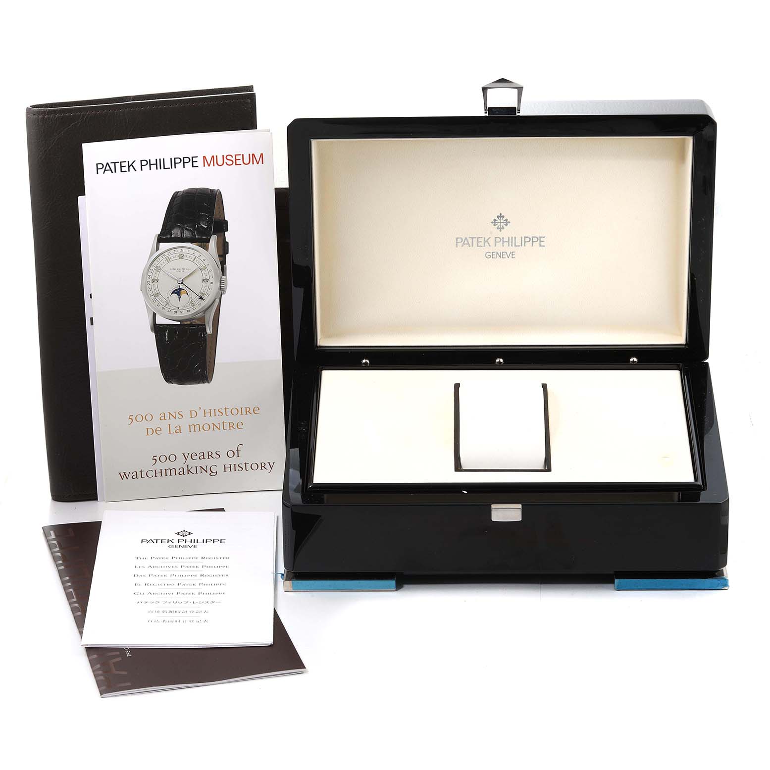 The image shows an open box for a Patek Philippe Complications 5131R Men's Rose Gold Silver Dial 5131R Men's Rose Gold Silver Dial watch, along with accompanying booklets and a cardholder.