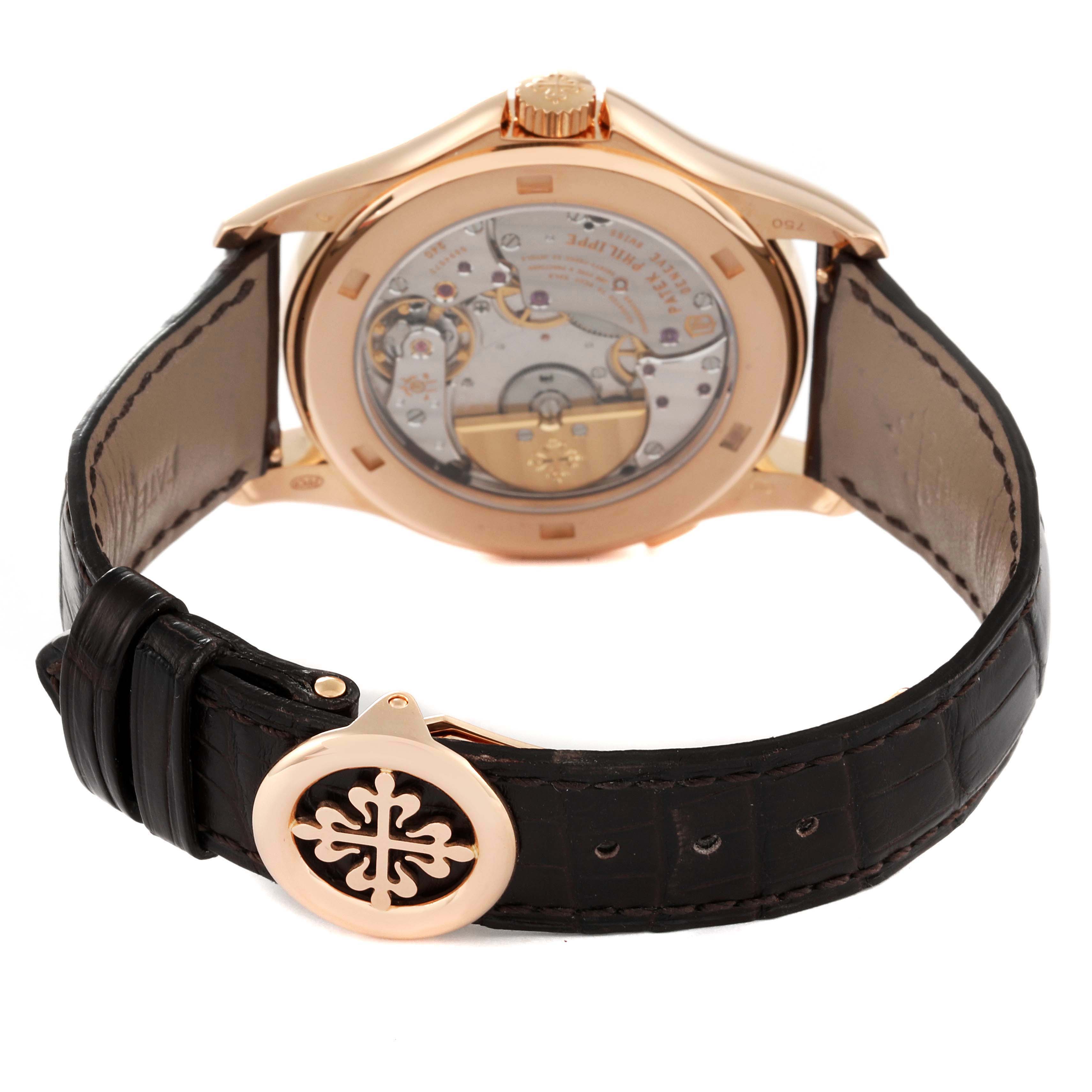 The image shows the back case and movement parts of the Patek Philippe Complications 5131R Men's Rose Gold Silver Dial 5131R Men's Rose Gold Silver Dial model with a leather strap and clasp displayed.