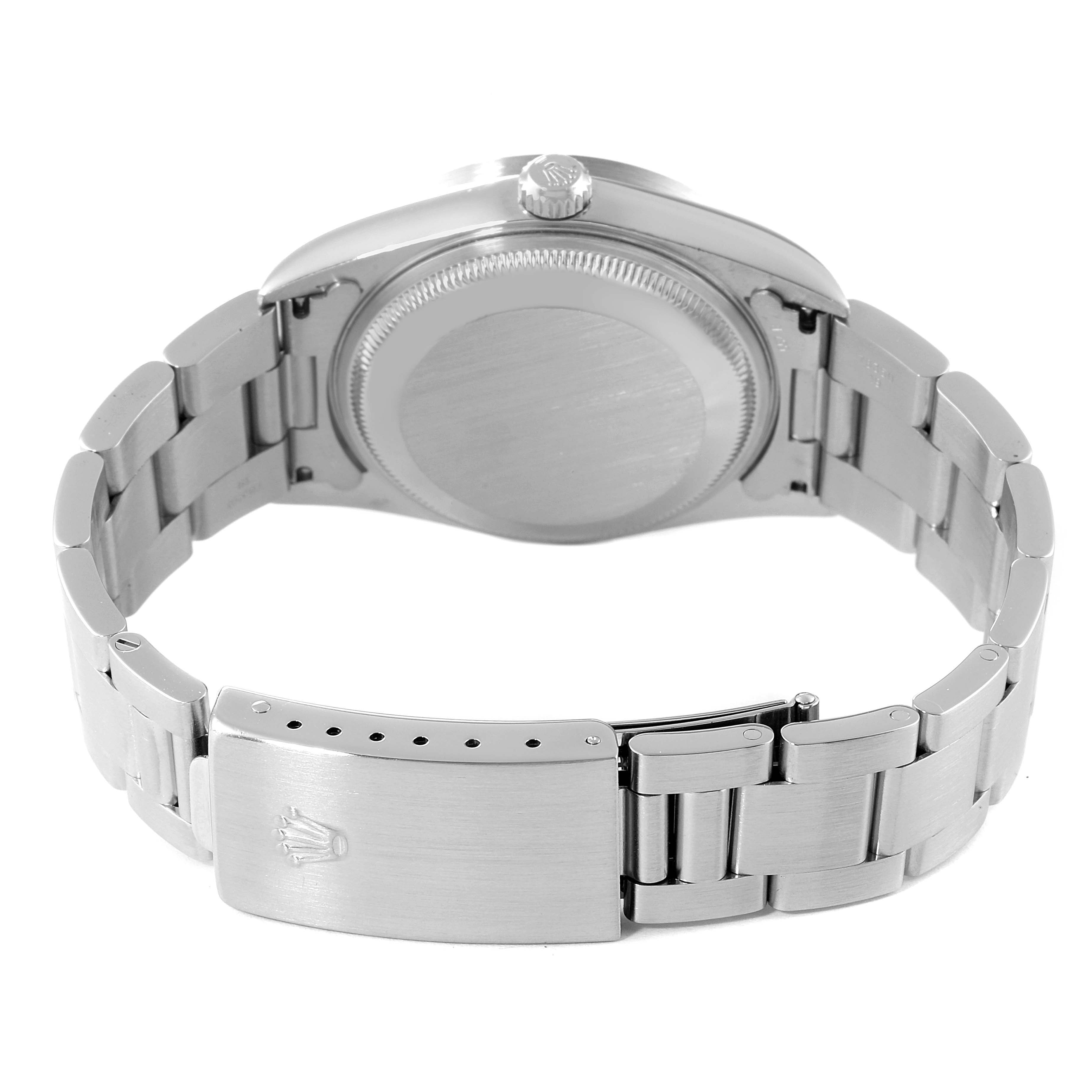 The image shows the back view of a Rolex Date 15210 Men's Stainless Steel Blue Dial 15210 Men's Stainless Steel Blue Dial watch, highlighting the case back, crown, and bracelet clasp.