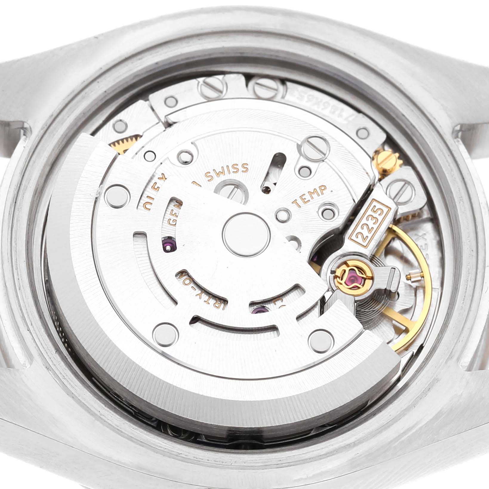 The image shows the movement of a Rolex Datejust 179384 Women's Stainless Steel Silver Dial watch from the back, highlighting gears and components.