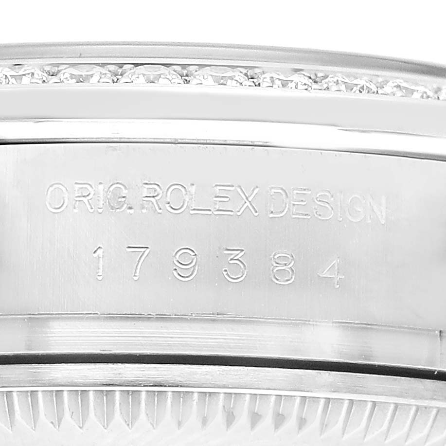 The image shows the side of a Rolex Datejust 179384 Women's Stainless Steel Silver Dial, focusing on the model number engraving and the bezel.