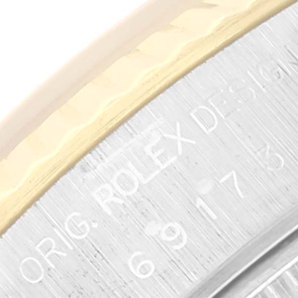This image shows a close-up of the bezel and side of a Rolex Datejust 69173 Women's Steel and Gold (two tone) Black Dial 69173 Women's Steel and Gold (two tone) Black Dial watch, highlighting the engraved text.