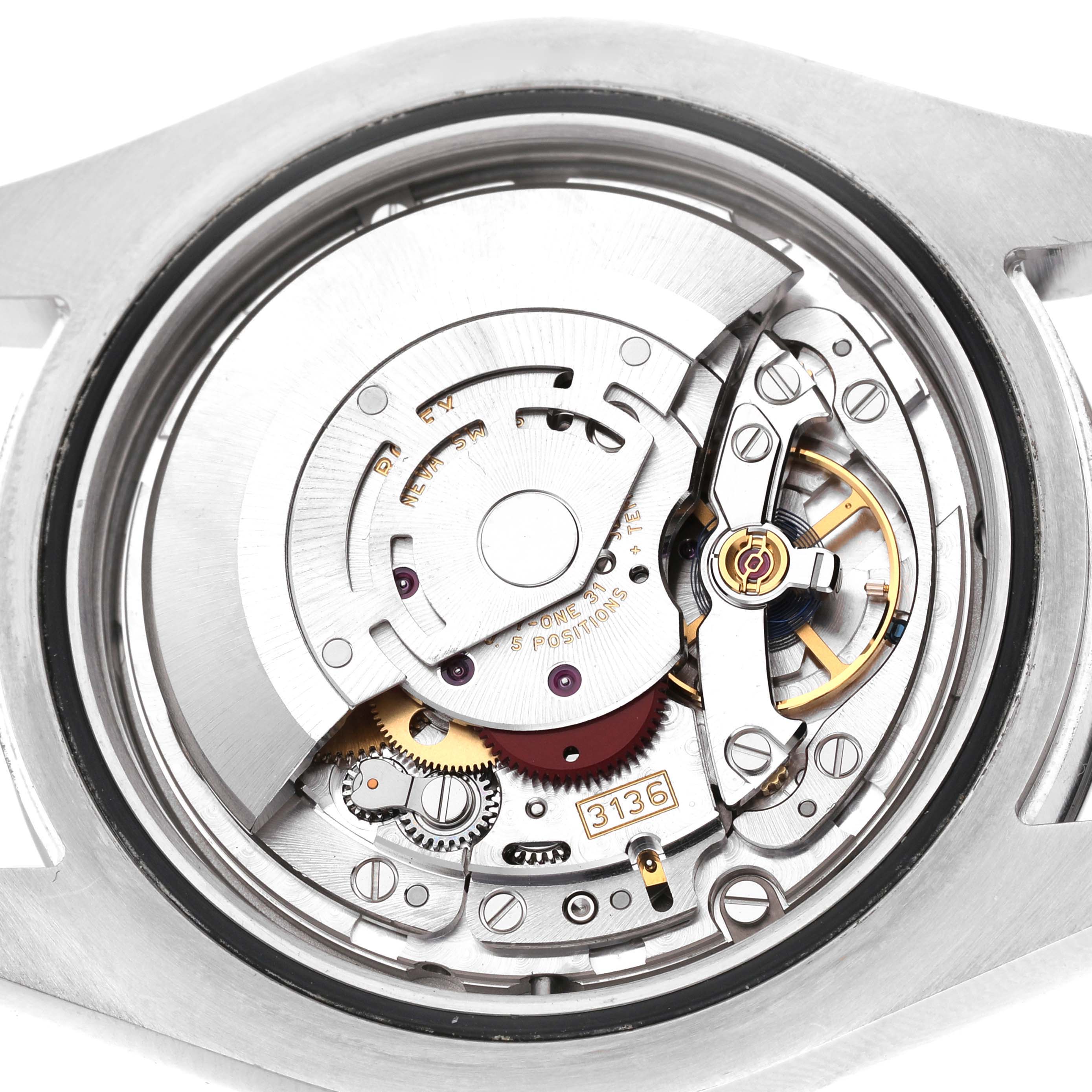 The image shows the movement of a Rolex Datejust 41 116300 Men's Stainless Steel Black Dial, featuring gears and components from the back.