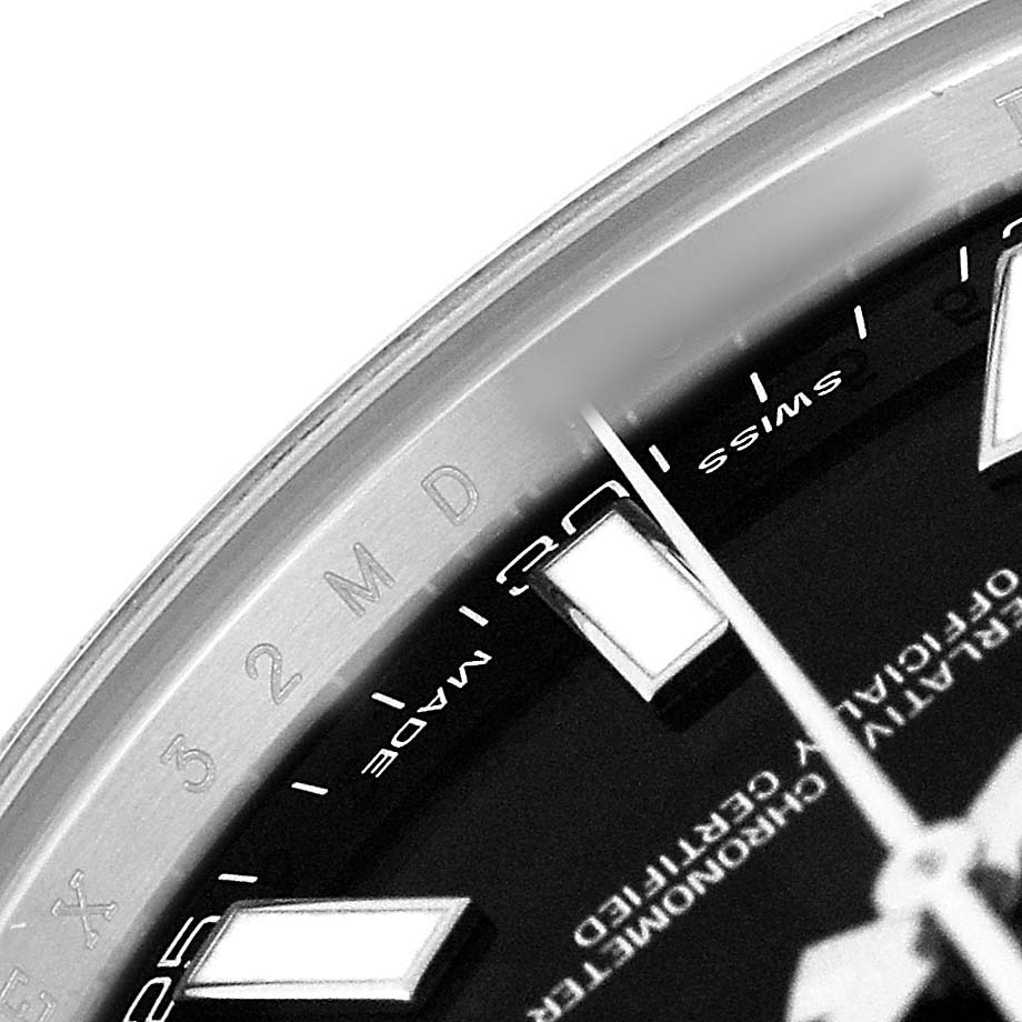 The image shows a close-up of the dial and a portion of the bezel of a Rolex Datejust 41 116300 Men's Stainless Steel Black Dial, emphasizing the markers and text.