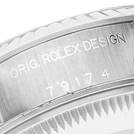 This image shows a close-up of a Rolex Datejust 79174 Women's Stainless Steel Blue Dial 79174 Women's Stainless Steel Blue Dial watch's bezel and engravings.