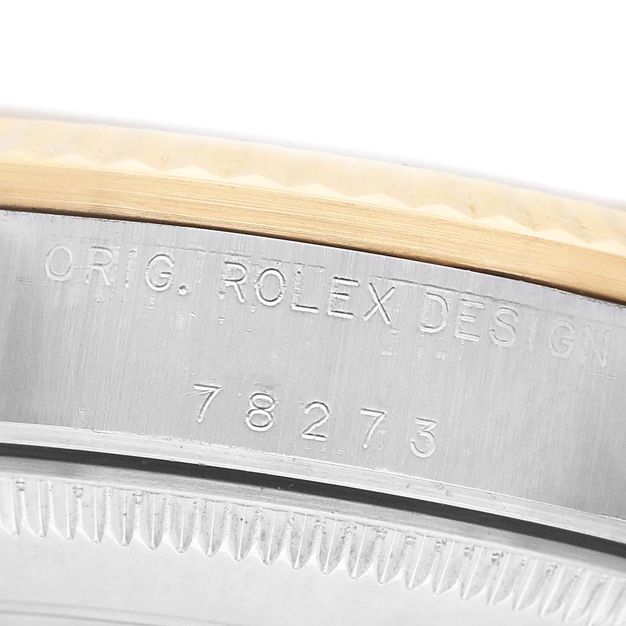 The image shows a close-up of the case side of a Rolex Mid-Size 78273 Women's Steel and Gold (two tone) Blue Dial model with engraved text and model number.