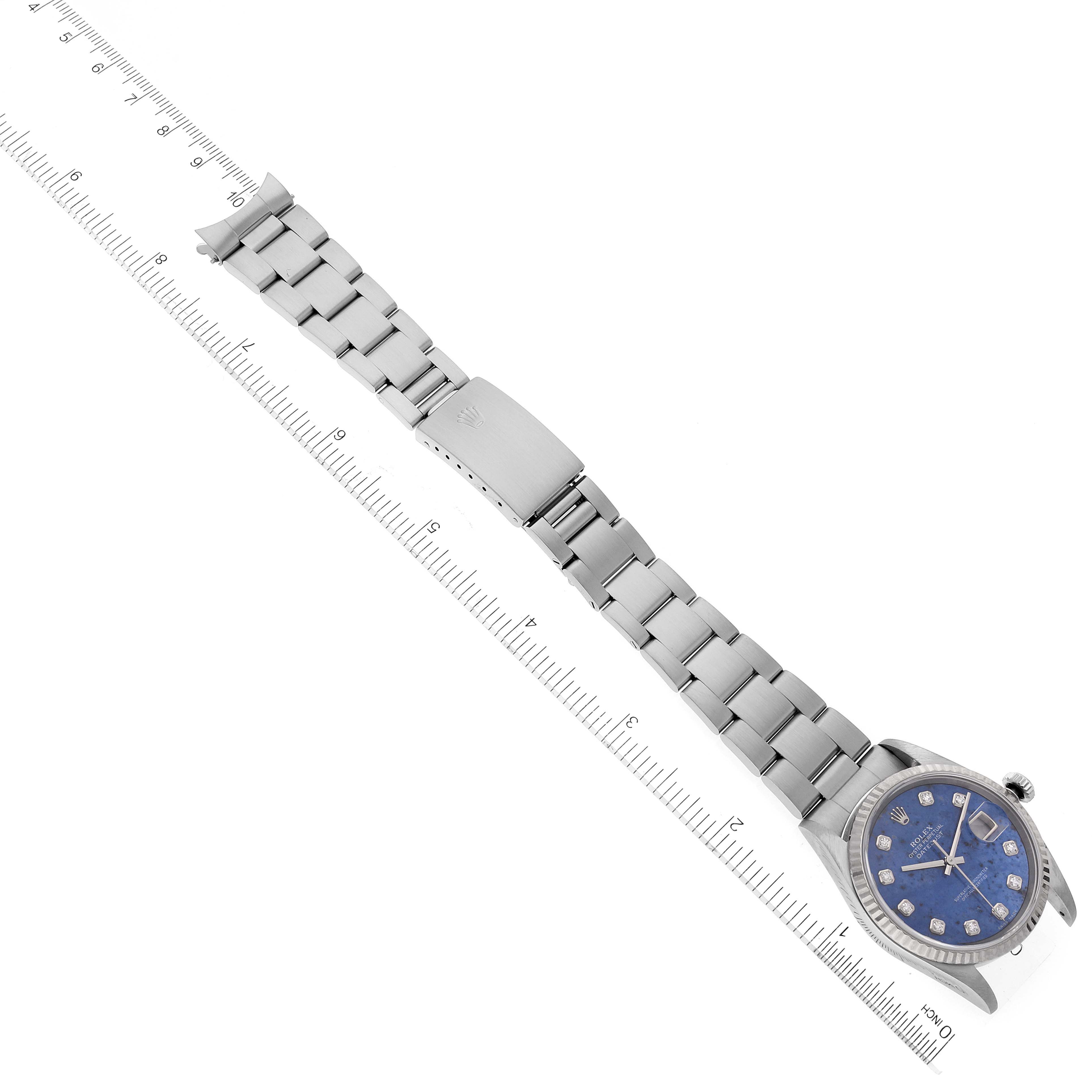 The image shows a Rolex Datejust 16234 Men's Stainless Steel Blue Dial 16234 Men's Stainless Steel Blue Dial watch laying flat, revealing its bracelet and face next to a measuring ruler.