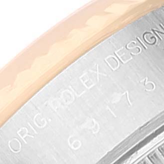 The image shows a close-up of the case back edge and part of the bezel of a Rolex Datejust 69173 Women's Steel and Gold (two tone) Silver Dial 69173 Women's Steel and Gold (two tone) Silver Dial watch with engravings visible.