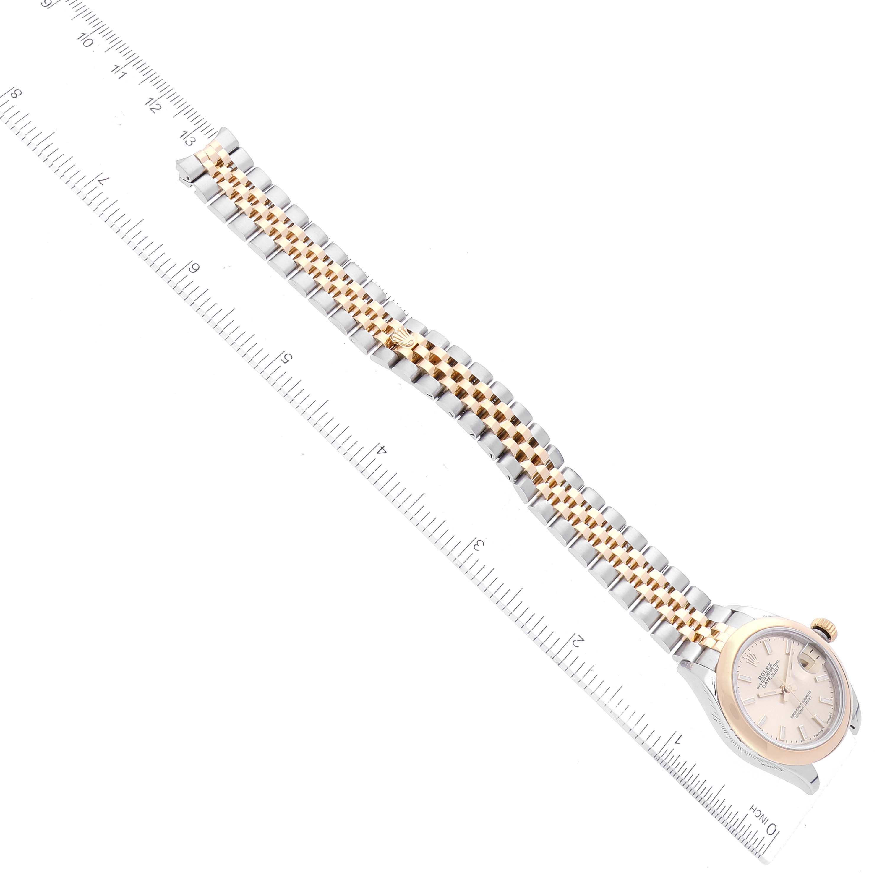 The Rolex Datejust 279163 Women's Steel and Gold (two tone) Champagne Dial 279163 Women's Steel and Gold (two tone) Champagne Dial watch is shown from a top-down angle, featuring the dial, case, and bracelet against a ruler for size reference.