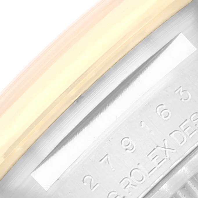 The image shows a close-up of the side of a Rolex Datejust 279163 Women's Steel and Gold (two tone) Champagne Dial 279163 Women's Steel and Gold (two tone) Champagne Dial watch bezel and part of the engraved serial number.