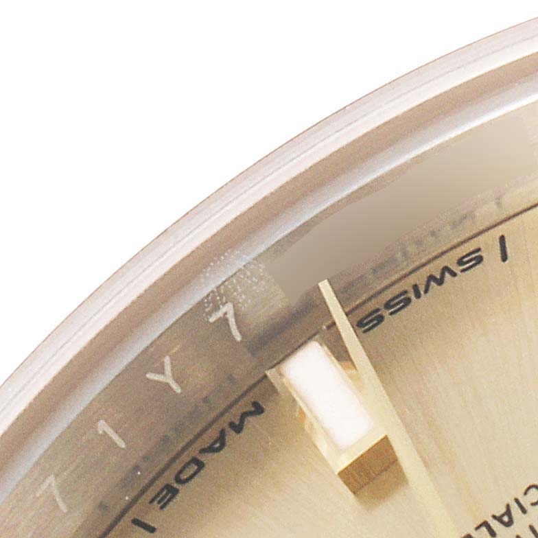 The image shows a close-up of the dial of a Datejust model by Rolex, highlighting the hour markers and part of the dial text.