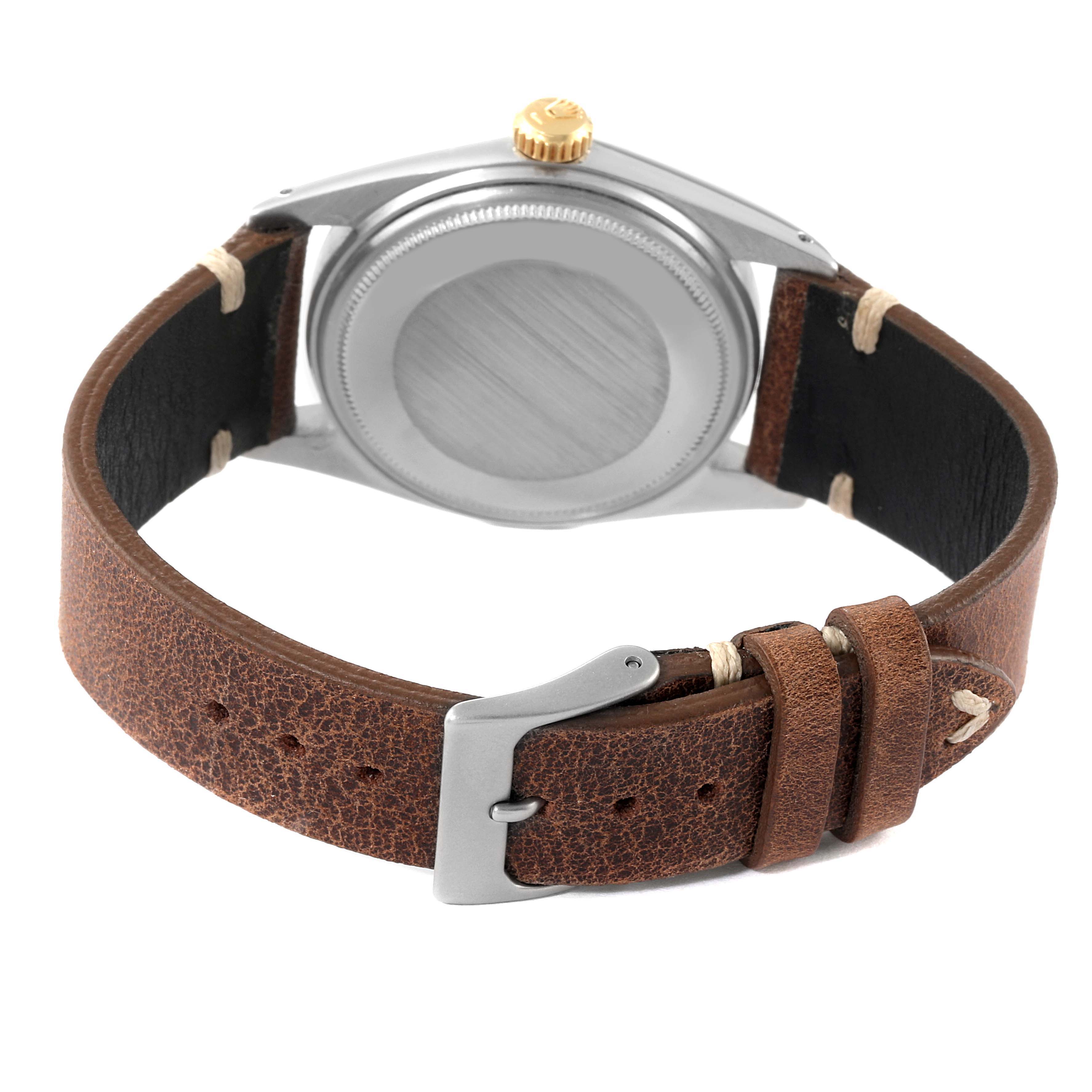 This image shows the back of a Rolex Datejust 1601 Men
s Steel and Gold (two tone) Champagne Dial 1601 Men
s Steel and Gold (two tone) Champagne Dial watch with a leather strap and buckle.