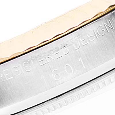 This image shows a close-up of the bezel and case side of a Rolex Datejust 1601 Men
s Steel and Gold (two tone) Champagne Dial 1601 Men
s Steel and Gold (two tone) Champagne Dial watch with engraved markings.