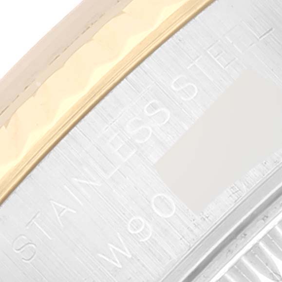 This close-up image shows the stainless steel part of the Rolex Datejust 69173 Women's Steel and Gold (two tone) White Dial 69173 Women's Steel and Gold (two tone) White Dial watch case, including some engraved text.
