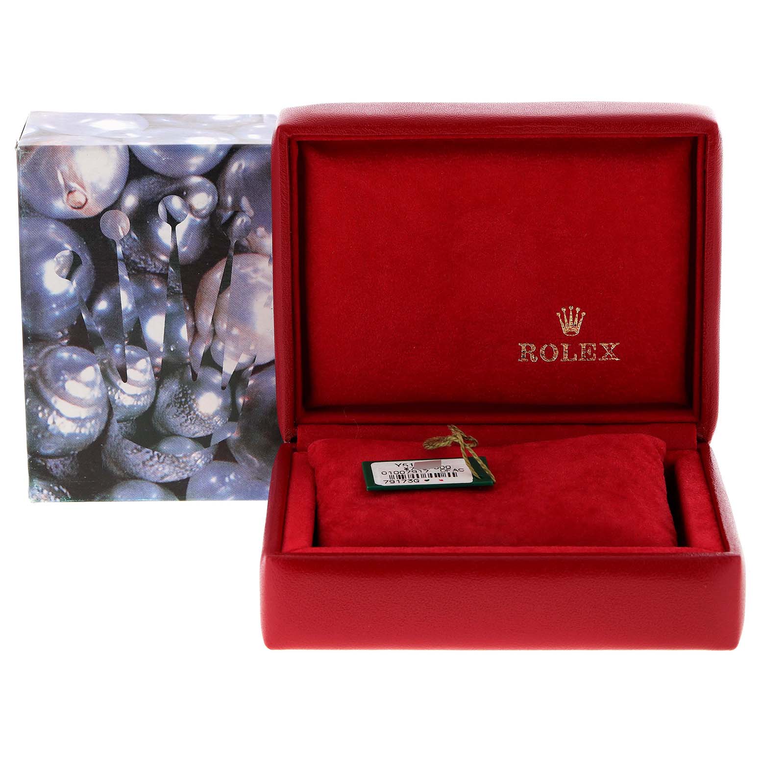 The image shows a red box and tag for a Rolex Datejust 79173 Women
s Steel and Gold (two tone) Champagne Dial 79173 Women
s Steel and Gold (two tone) Champagne Dial model, with the box lid open revealing a tag, and the exterior packaging beside it.