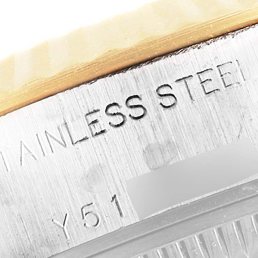 This is a close-up of the casing side of a Rolex Datejust 79173 Women
s Steel and Gold (two tone) Champagne Dial 79173 Women
s Steel and Gold (two tone) Champagne Dial watch, showing "STAINLESS STEEL" engraving.