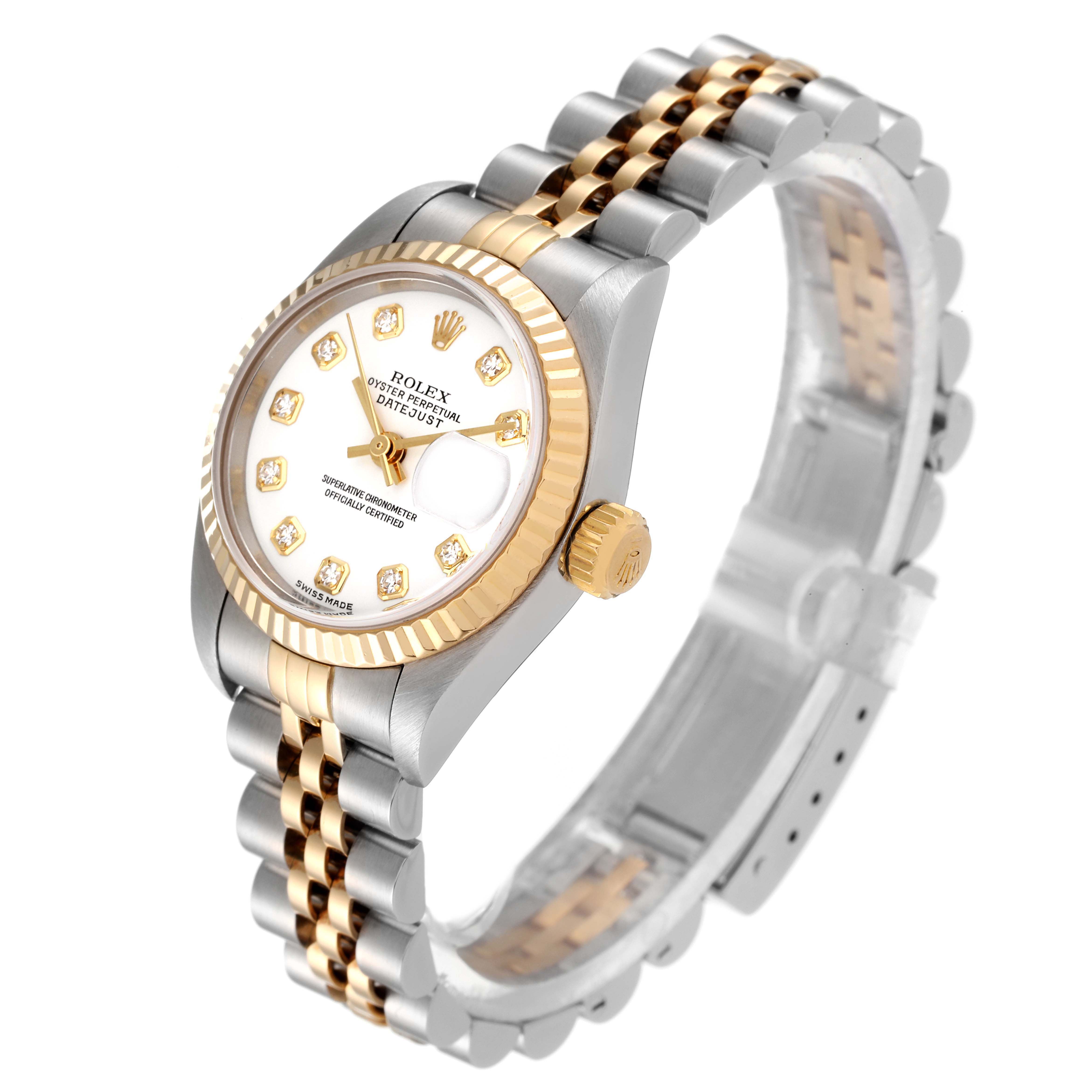 The image shows a Rolex Datejust 79173 Women
s Steel and Gold (two tone) White Dial 79173 Women
s Steel and Gold (two tone) White Dial watch at an angle displaying the face, bezel, crown, and part of the bracelet.