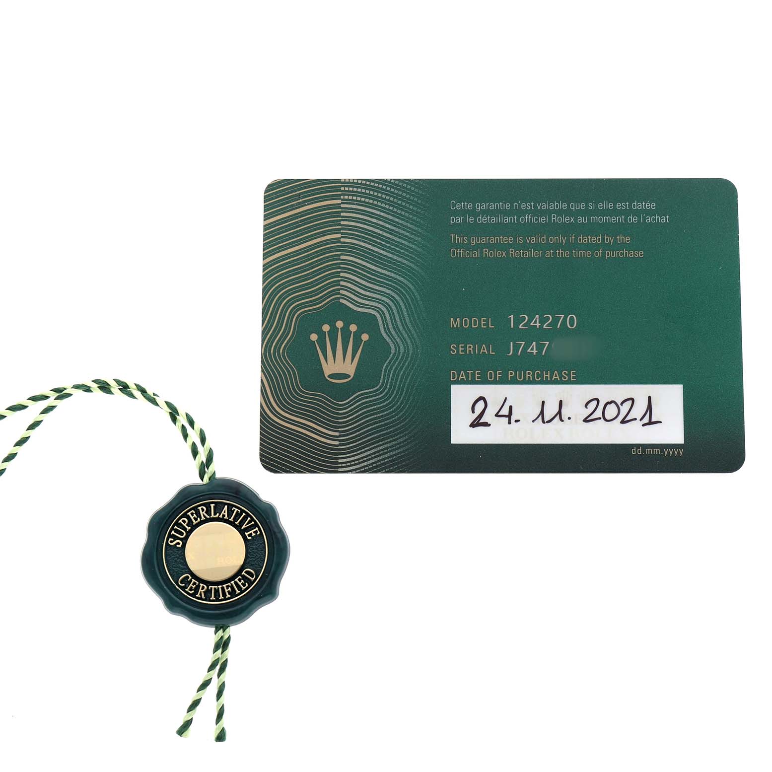 The image shows a green Rolex warranty card and a "Superlative Certified" tag for the Explorer model 124270.