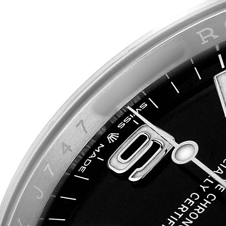The image shows a close-up of the dial and bezel of the Rolex Explorer 124270 Men's Stainless Steel Black Dial, highlighting the hour markers and "Swiss Made" text.