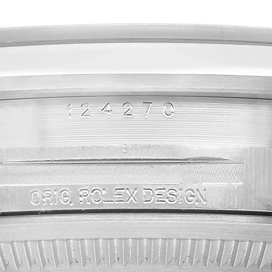 The image shows the side of the Rolex Explorer 124270 Men's Stainless Steel Black Dial watch case, featuring engraved model details and the phrase "ORIG. ROLEX DESIGN."