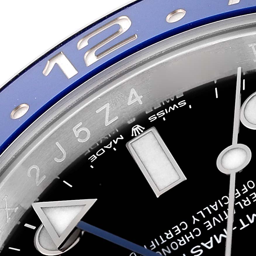 This image shows a close-up of the bezel and part of the dial of a Rolex GMT-Master 126710 Men
s Stainless Steel Black Dial 126710 Men
s Stainless Steel Black Dial watch, highlighting the 12-hour marker.