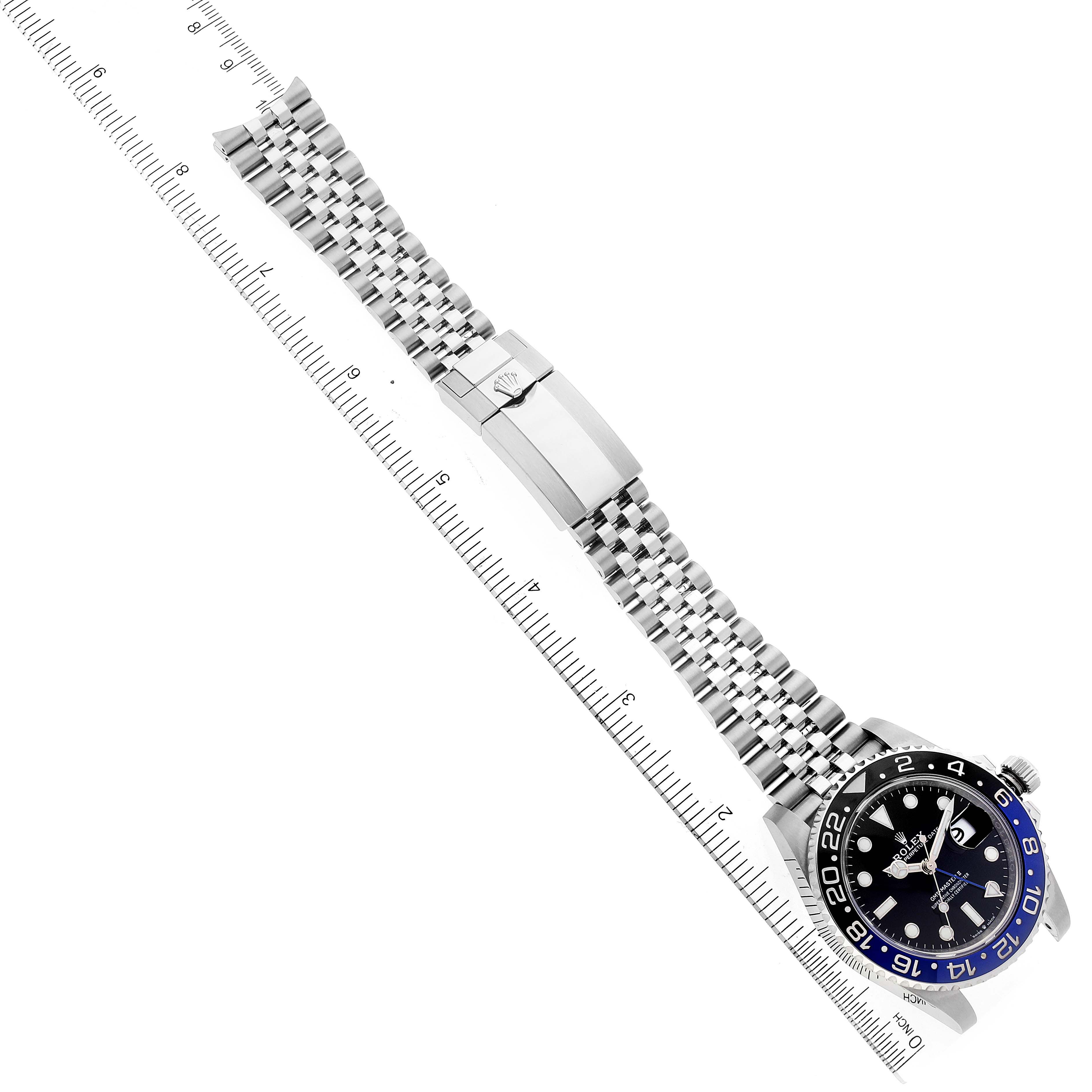 The Rolex GMT-Master 126710 Men
s Stainless Steel Black Dial 126710 Men
s Stainless Steel Black Dial watch is shown laid flat with its face and bracelet fully visible next to a measuring ruler.