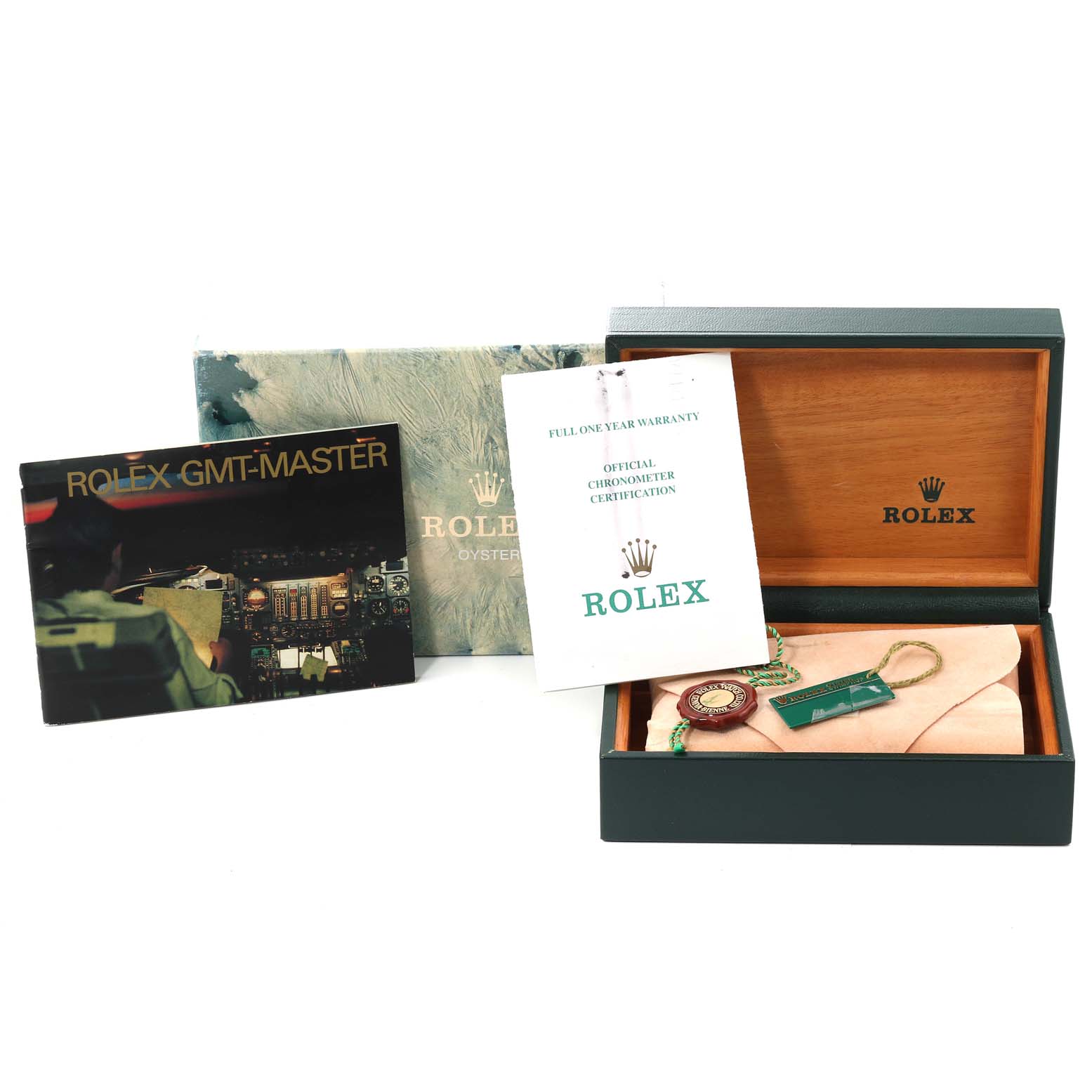 The image shows the packaging and accessories for a Rolex GMT-Master 16710 Men
s Stainless Steel Black Dial 16710 Men
s Stainless Steel Black Dial, including its box, warranty card, certificate, and tags.