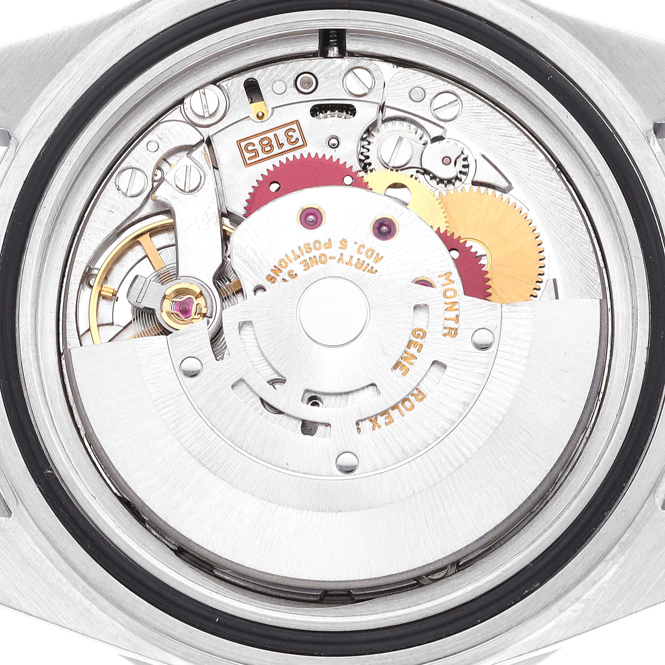 The image shows a close-up of the movement mechanism in a Rolex GMT-Master 16710 Men
s Stainless Steel Black Dial 16710 Men
s Stainless Steel Black Dial watch, highlighting its internal gears and components.