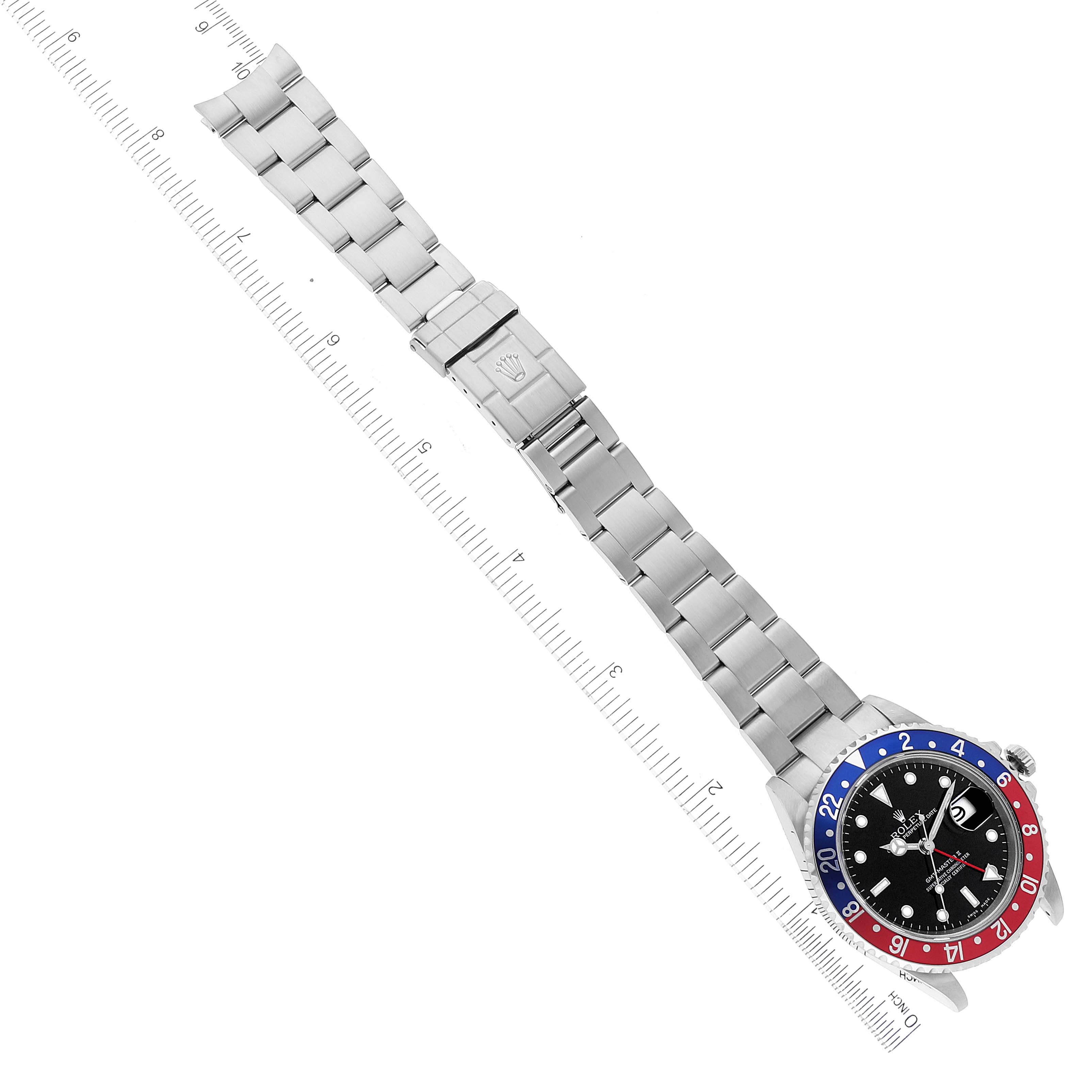 The image shows the top view of a Rolex GMT-Master 16710 Men's Stainless Steel Black Dial 16710 Men's Stainless Steel Black Dial watch, displaying its metal bracelet and the watch face with a red and blue bezel.