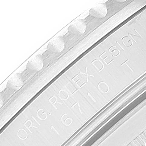 The image shows a close-up of the side of a Rolex GMT-Master 16710 Men's Stainless Steel Black Dial 16710 Men's Stainless Steel Black Dial watch, specifically the bezel and the engraving "ORIG. ROLEX DESIGN 16710 T".