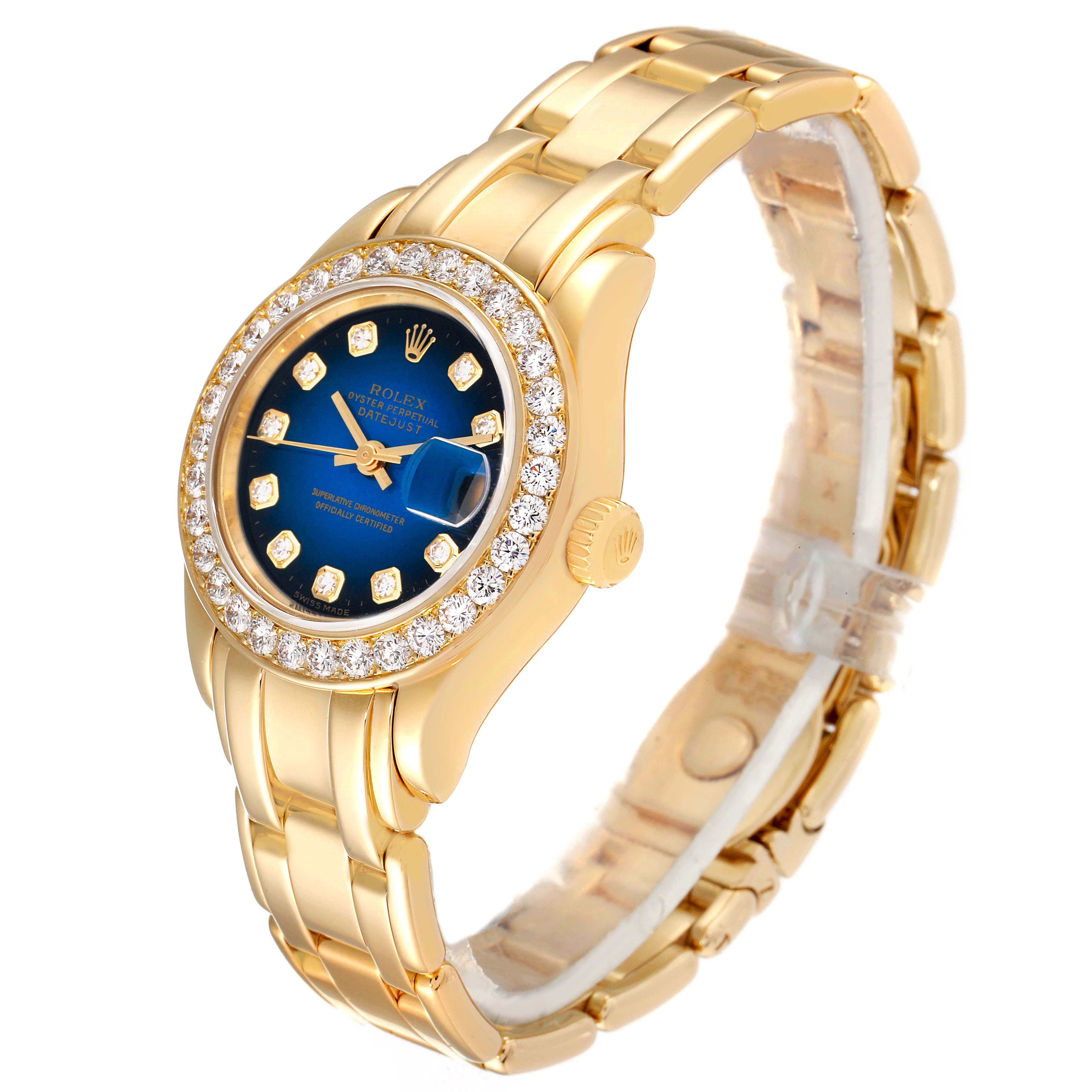 The Rolex Pearlmaster 69298 Women's Yellow Gold Blue Dial 69298 Women's Yellow Gold Blue Dial watch is shown at a three-quarter angle, highlighting its gold band, blue dial, and diamond-encrusted bezel.
