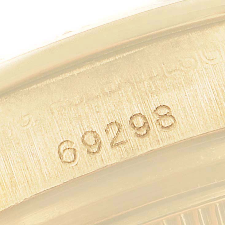 The image shows a close-up of the Rolex Pearlmaster 69298 Women's Yellow Gold Blue Dial 69298 Women's Yellow Gold Blue Dial model's case with the engraved number "69298."