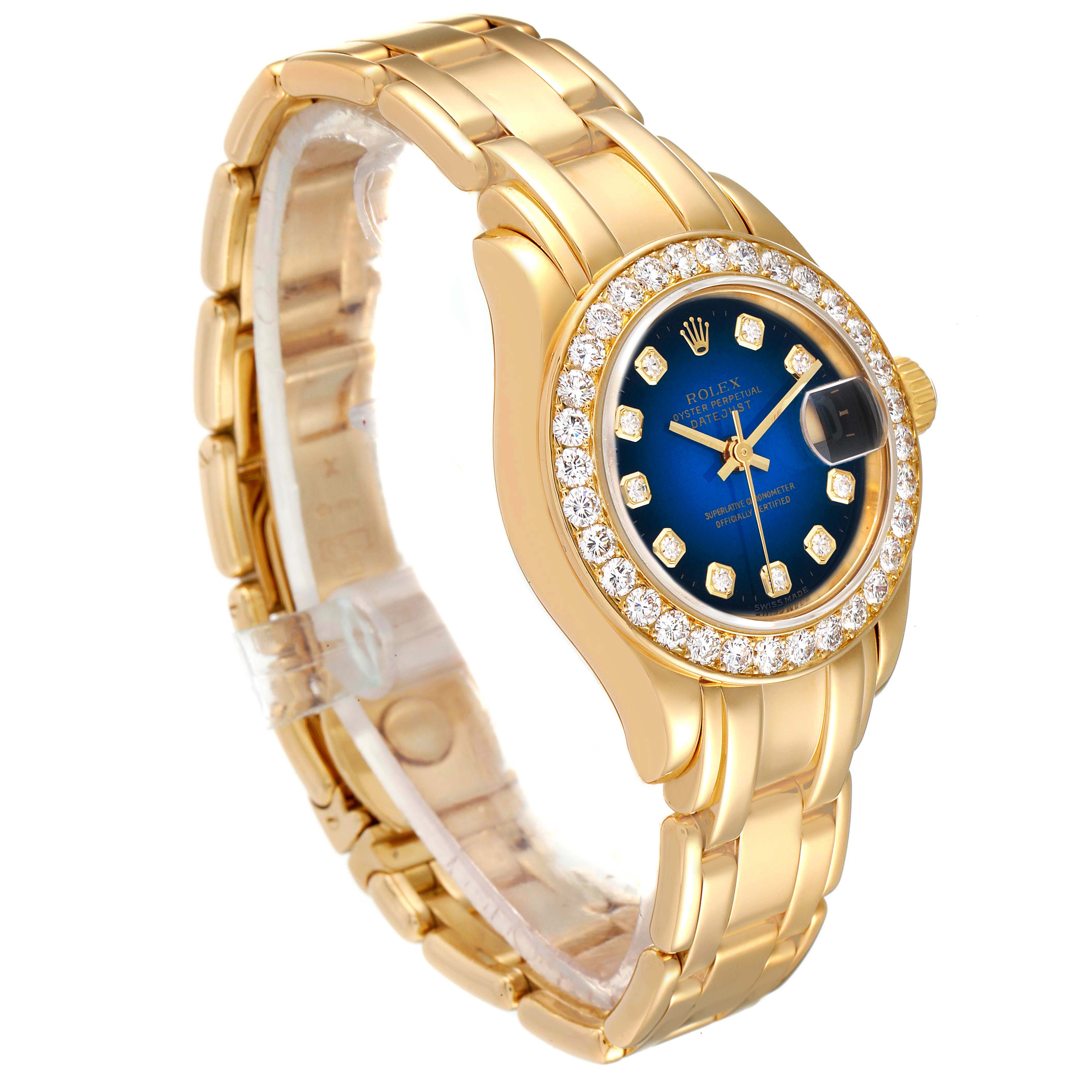 The Rolex Pearlmaster 69298 Women's Yellow Gold Blue Dial 69298 Women's Yellow Gold Blue Dial watch is shown at an oblique angle, highlighting its gold bracelet, diamond-encrusted bezel, and blue dial.
