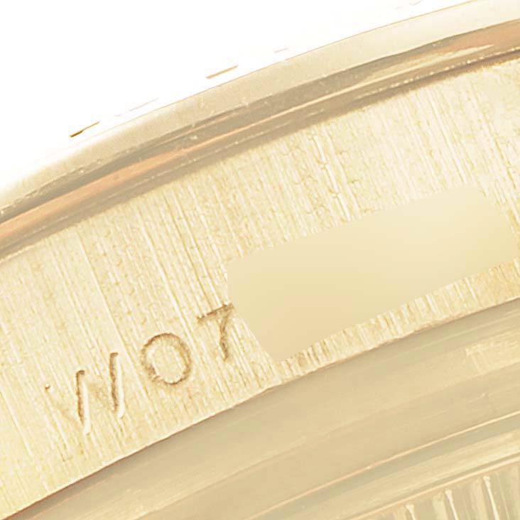 This is a close-up angle focusing on the serial number engraving on the case of a Rolex Pearlmaster 69298 Women's Yellow Gold Mother of Pearl Dial 69298 Women's Yellow Gold Mother of Pearl Dial watch.
